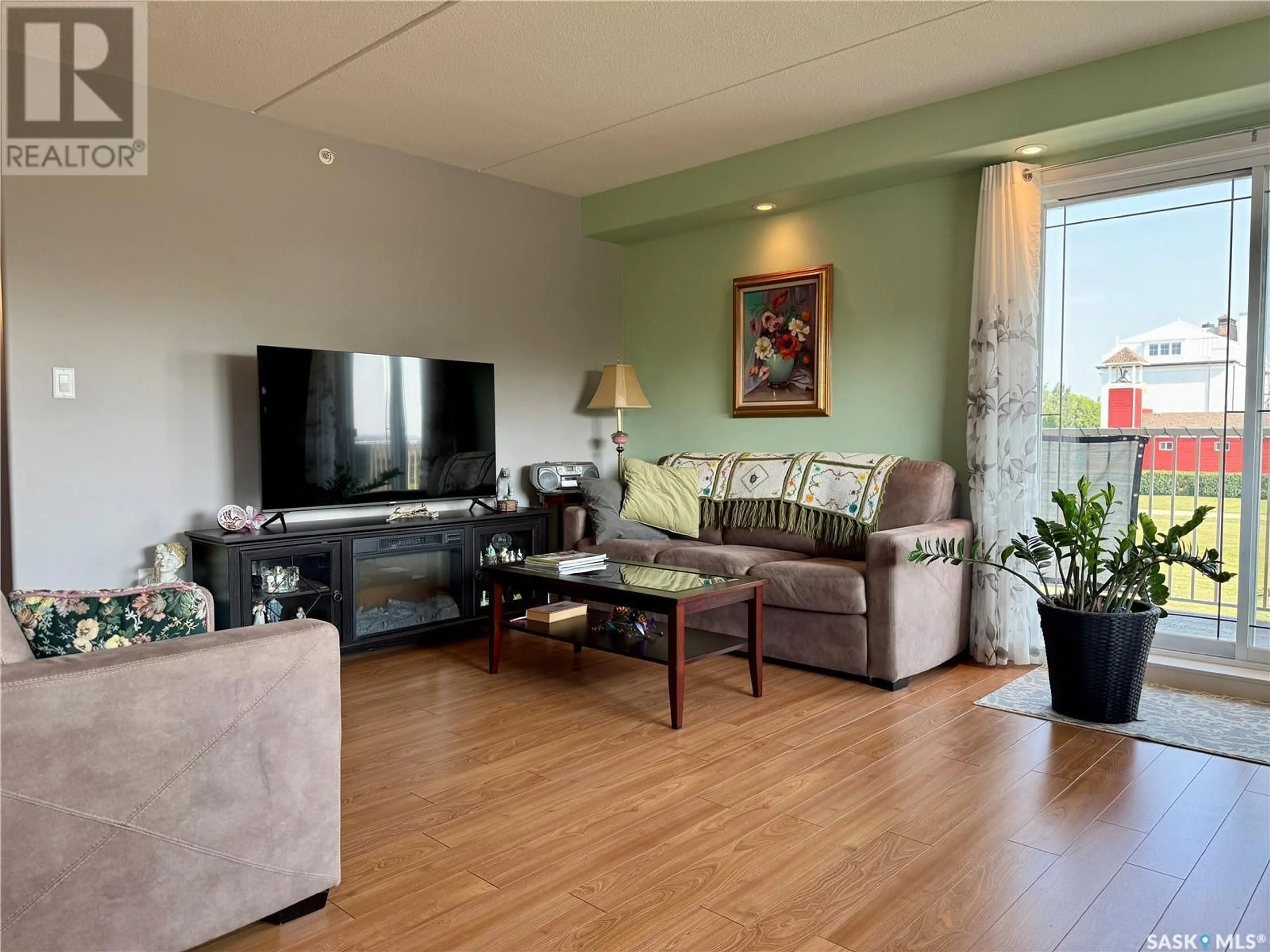 Living room with furniture, wood/laminate floor for 207 2 18TH STREET, Battleford Saskatchewan S0M0E0