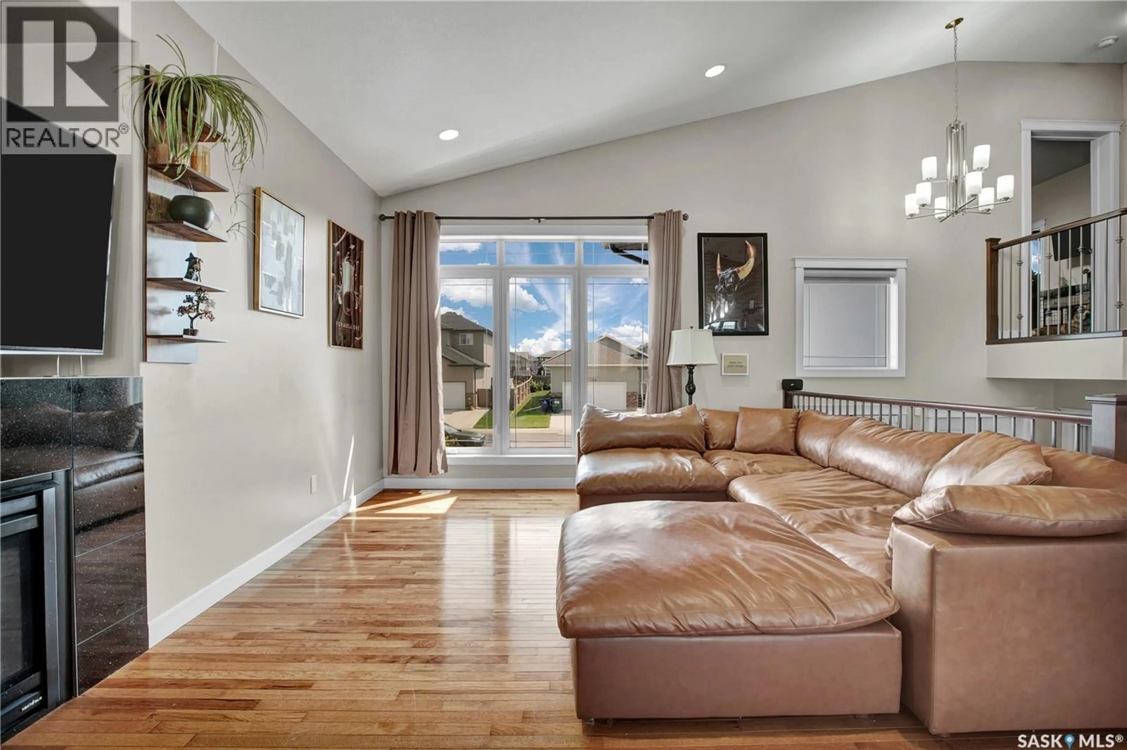 Living room with furniture, wood/laminate floor for 251 MCCALLUM WAY, Saskatoon Saskatchewan S7R0H7