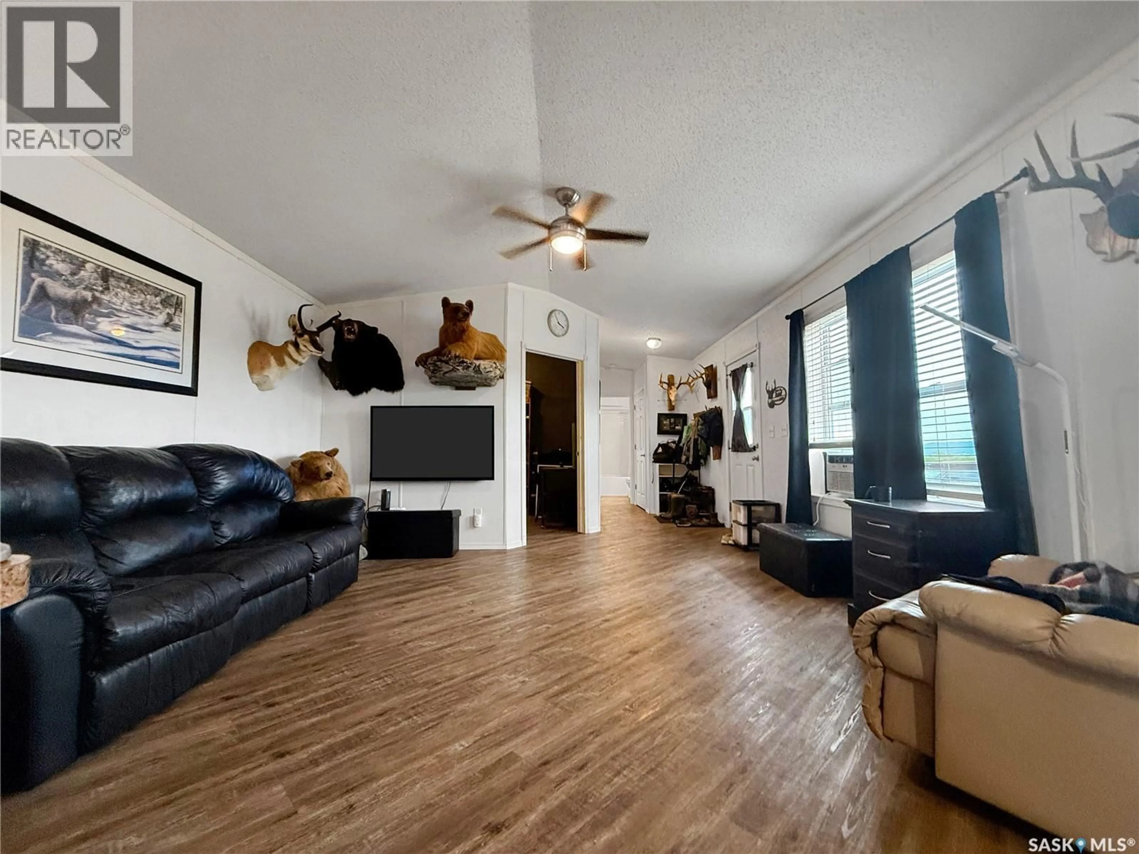 Living room with furniture, wood/laminate floor for 300 ISOBEL AVENUE, Tantallon Saskatchewan S0A4B0