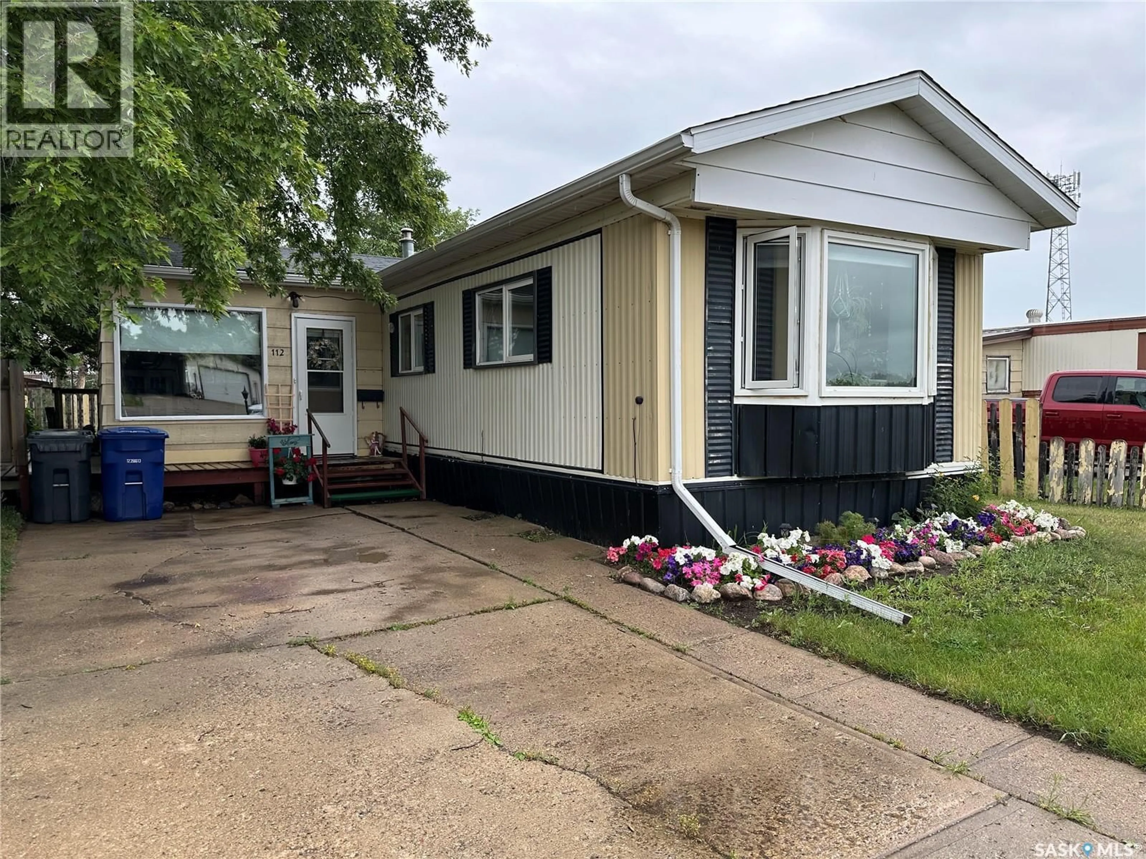 Home with vinyl exterior material, street for 112 17TH STREET, Weyburn Saskatchewan S4H2N4