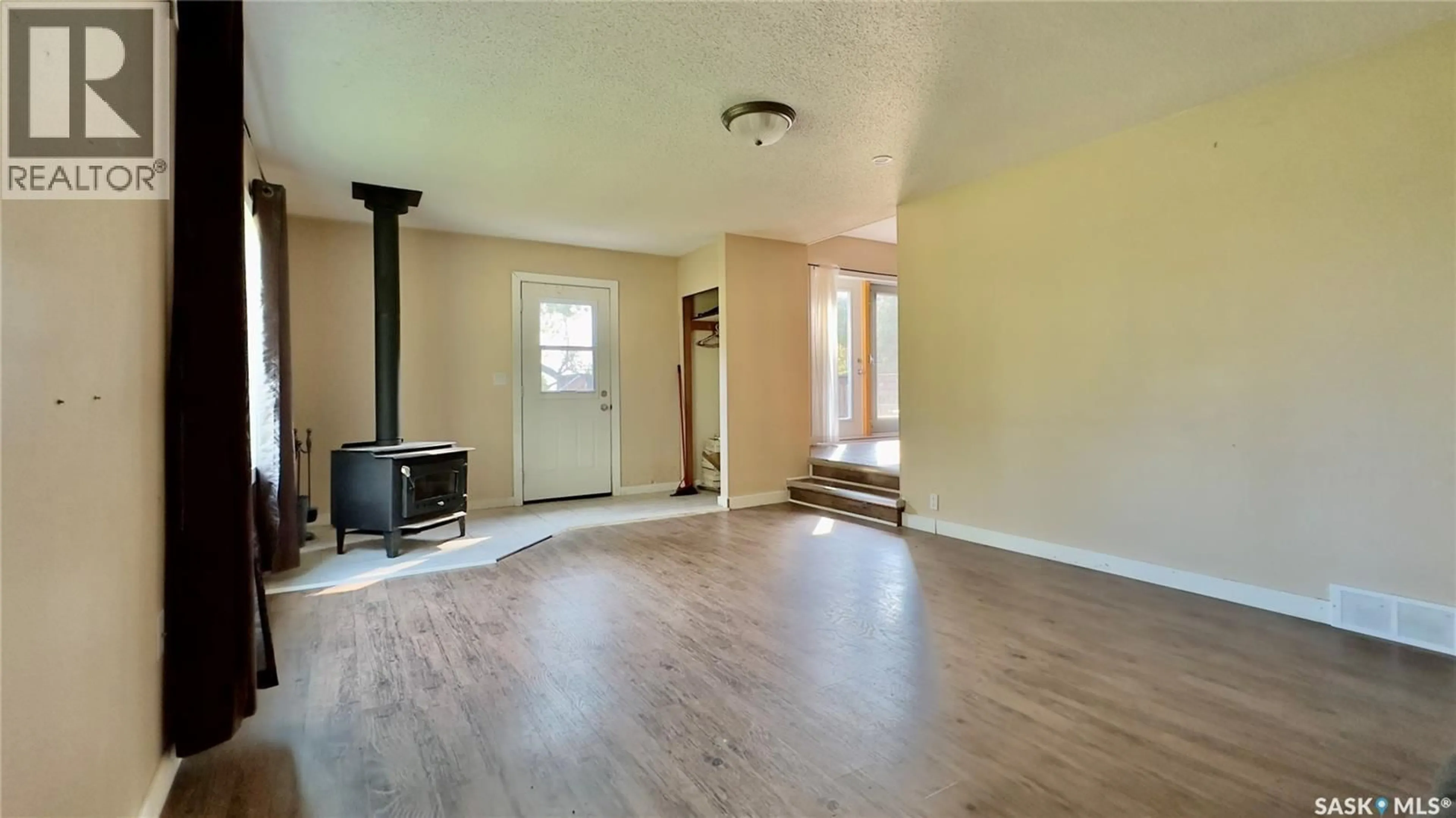 Living room with furniture, wood/laminate floor for Robinson - MERVIN ACREAGE, Mervin Rm No.499 Saskatchewan S0M0Y0