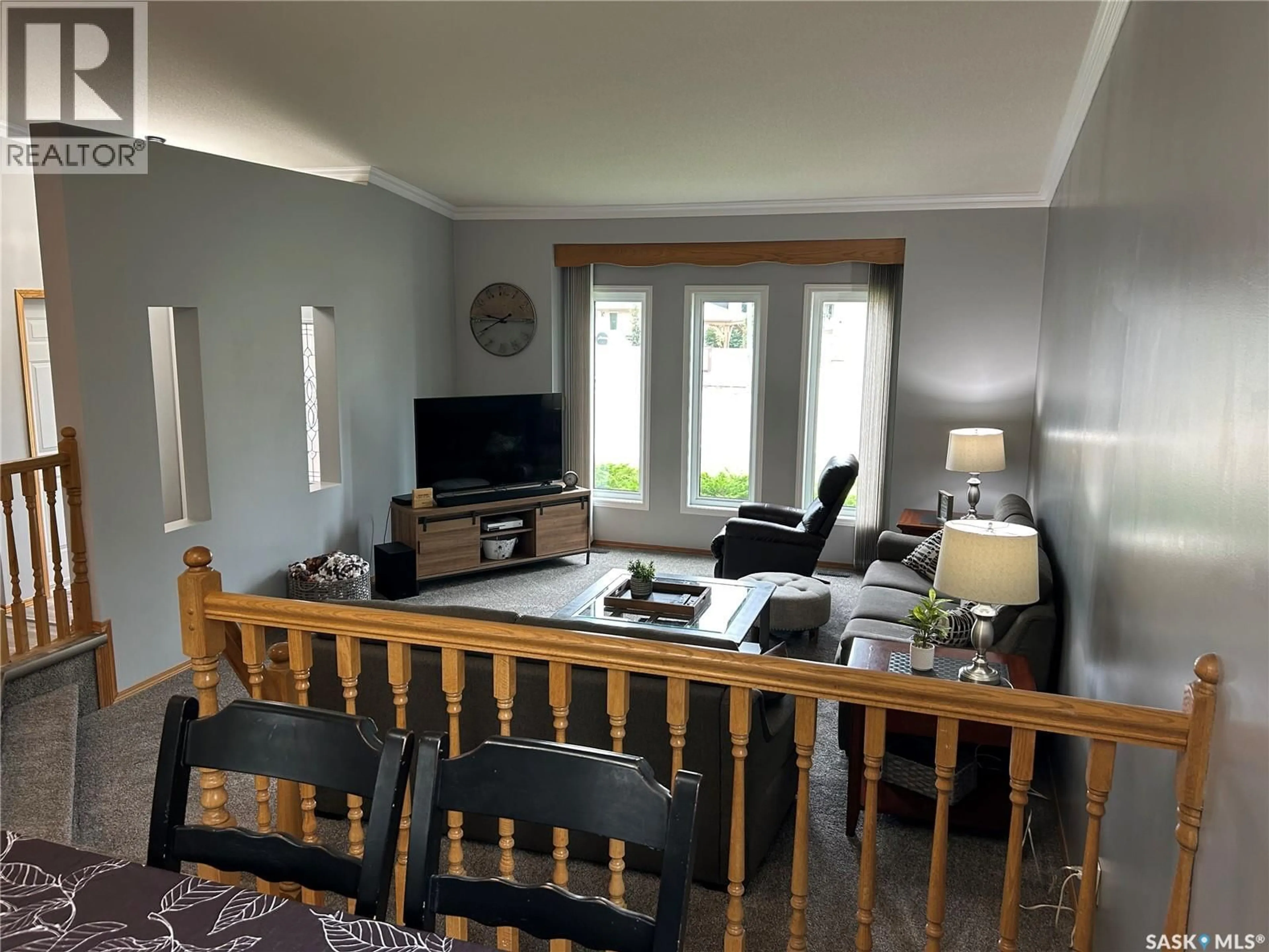 Living room with furniture, wood/laminate floor for 2239 NEWCOMBE DRIVE, Estevan Saskatchewan S4A2S5