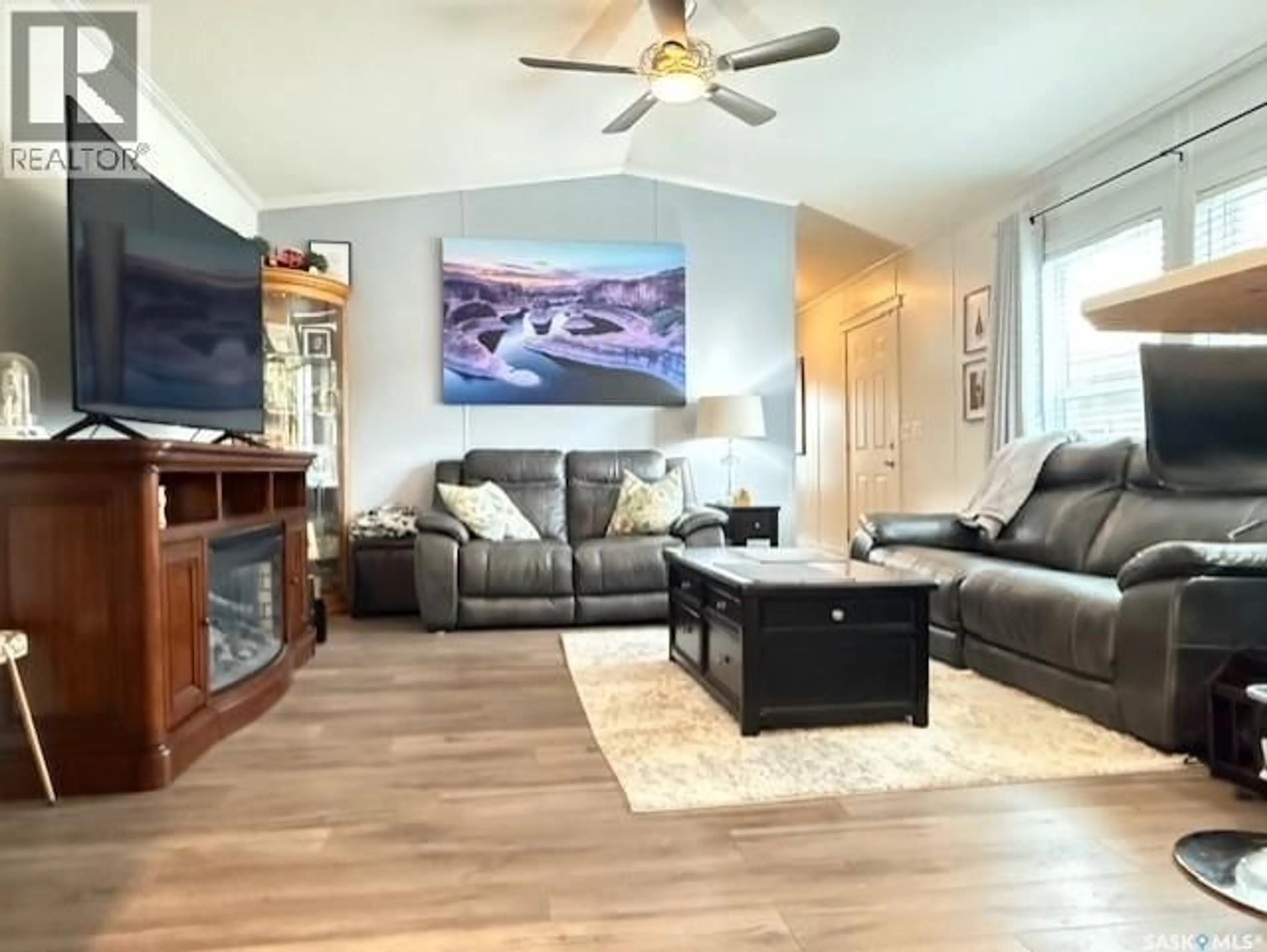 Living room with furniture, wood/laminate floor for 2 555 DIELSCHNEIDER ROAD, Melville Saskatchewan S0A2P0