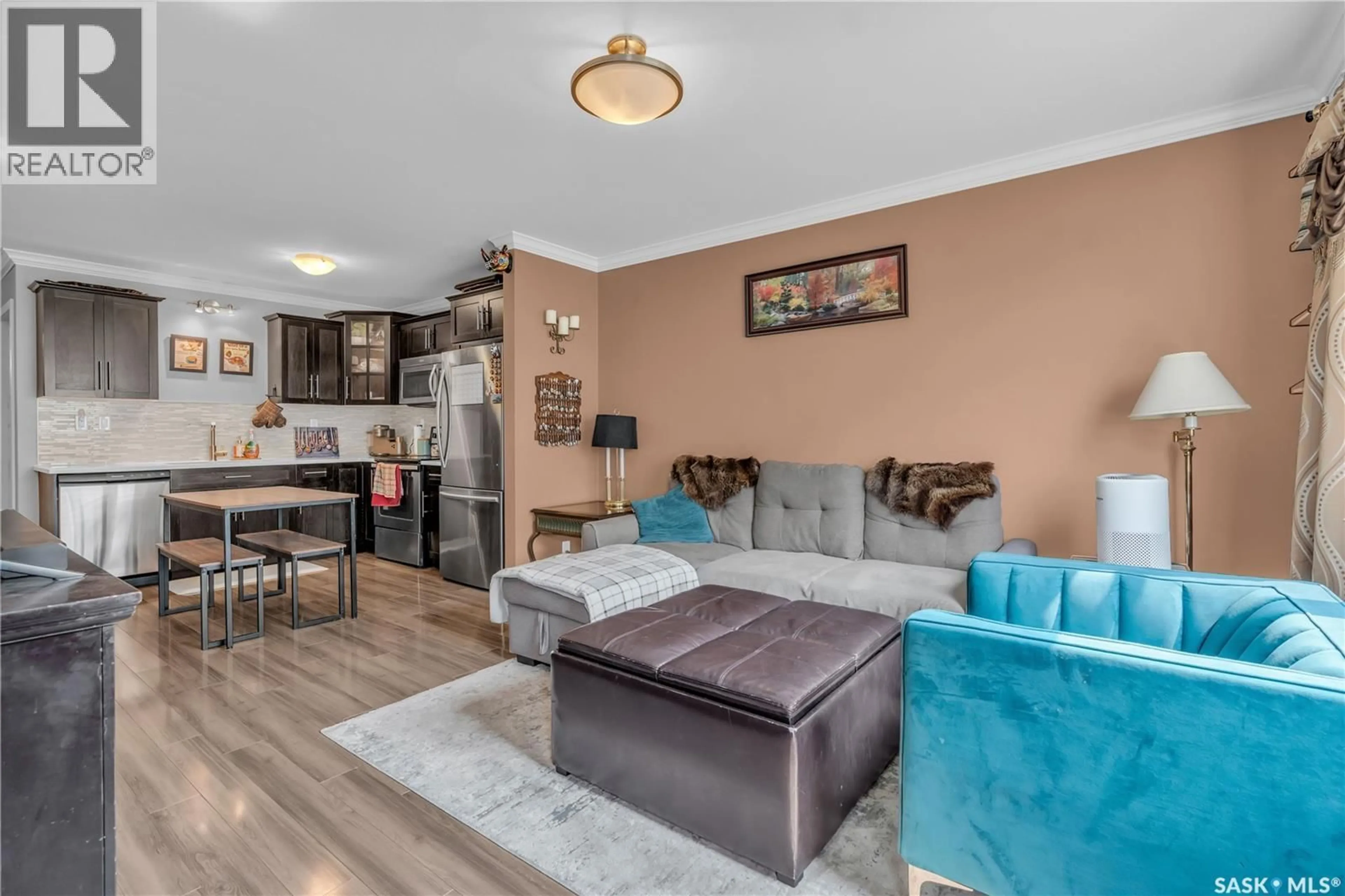 Living room with furniture, wood/laminate floor for 130 - 1215 MARLATTE CRESCENT, Saskatoon Saskatchewan S7W0W1