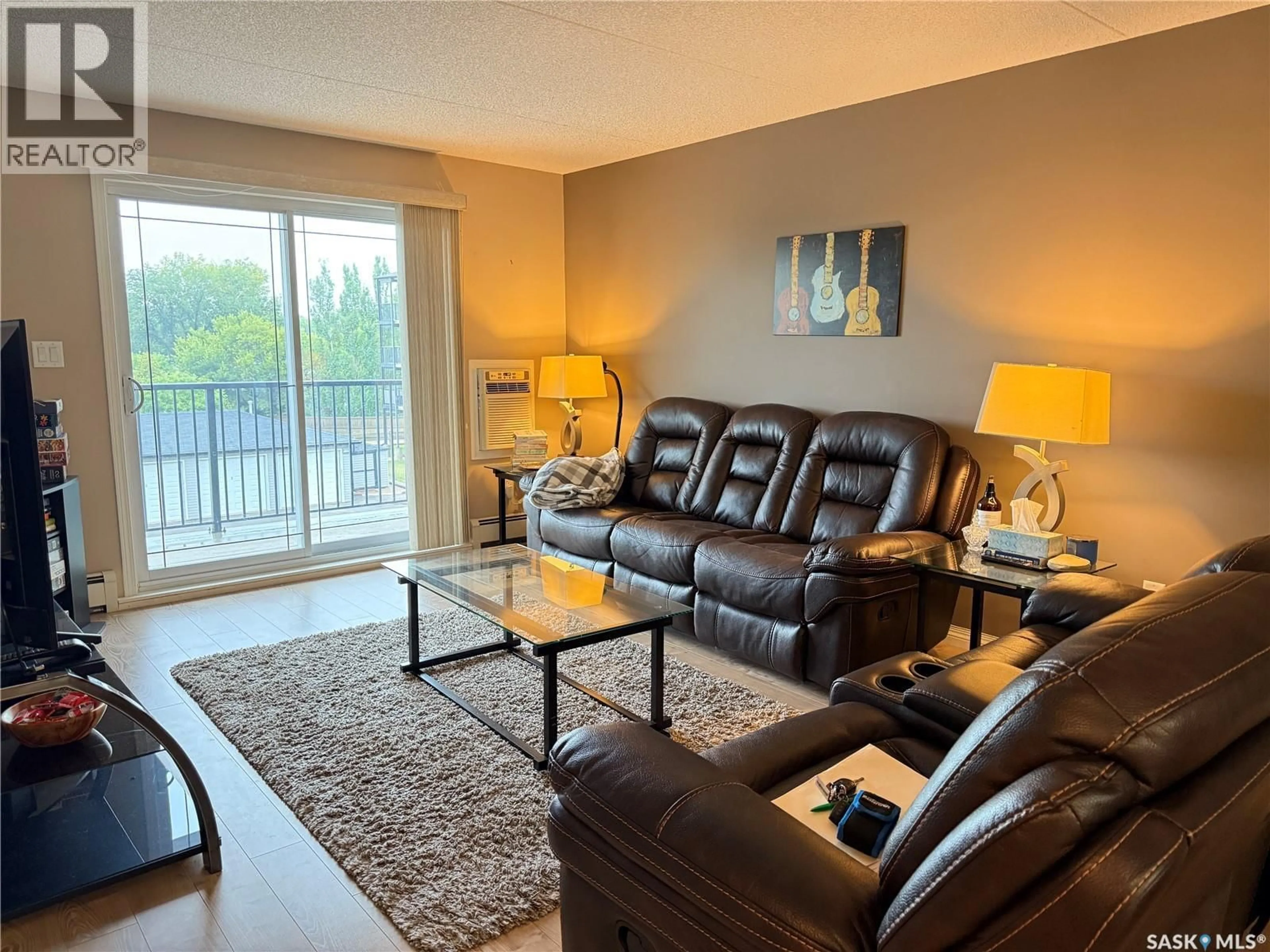 Living room with furniture, wood/laminate floor for 306 - 505 BANNERMAN STREET, Weyburn Saskatchewan S4H1V5
