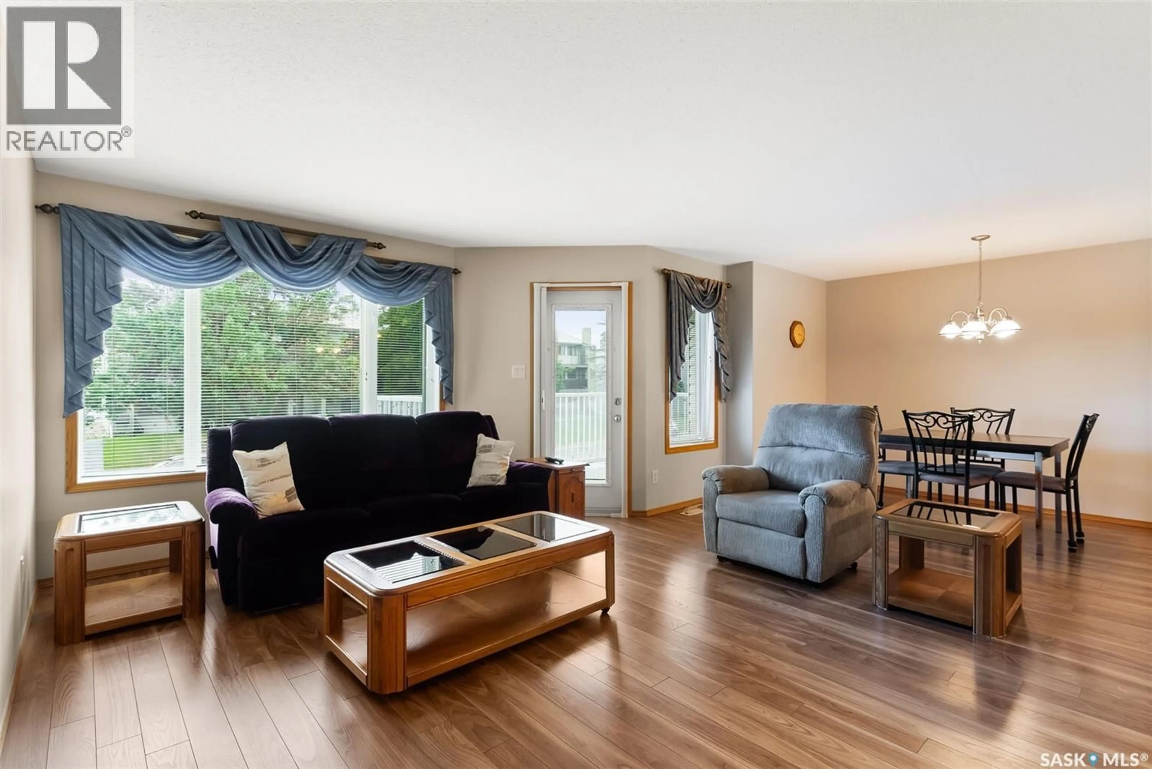 Living room with furniture, wood/laminate floor for 6 - 204 LORNE PLACE, Regina Saskatchewan S4R8B3
