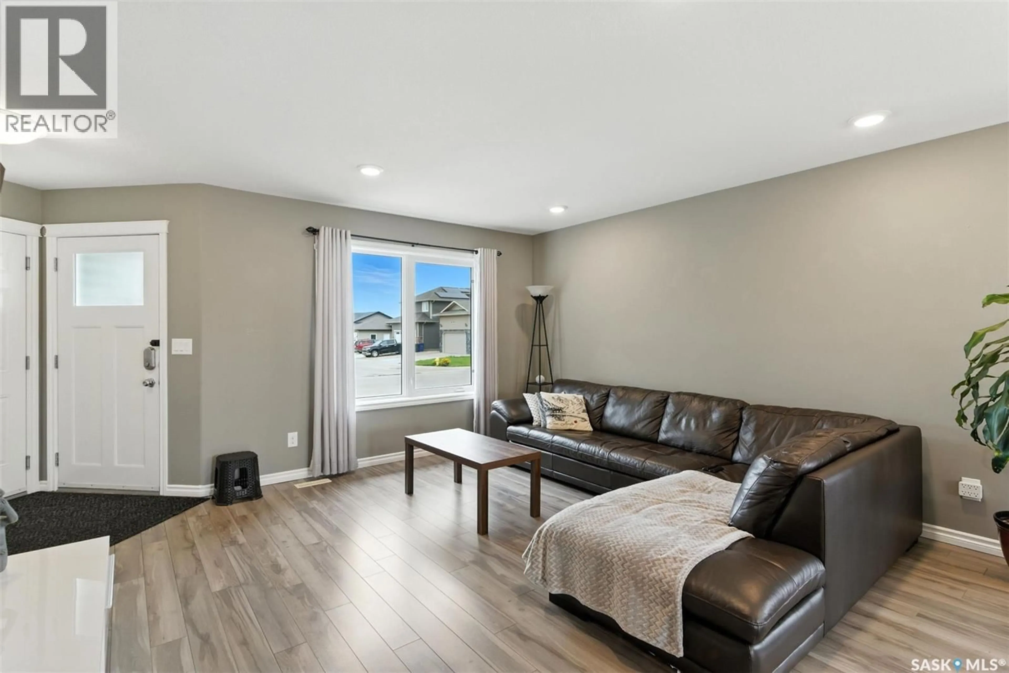 Living room with furniture, wood/laminate floor for 960 REIMER ROAD, Martensville Saskatchewan S0K0A2
