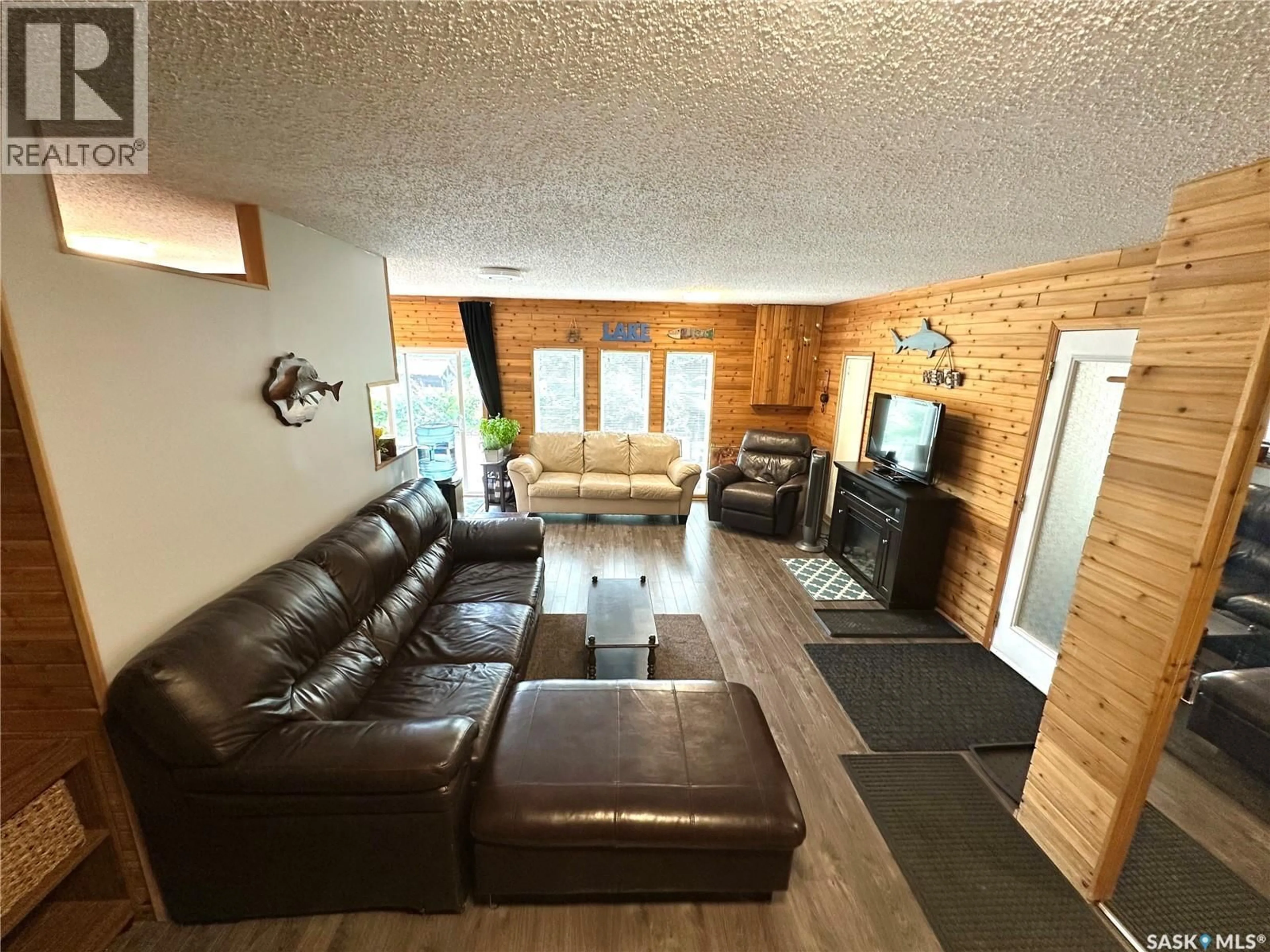 Living room with furniture, wood/laminate floor for 213 LAKEVIEW AVENUE, Canwood Rm No. 494 Saskatchewan S0J2X0