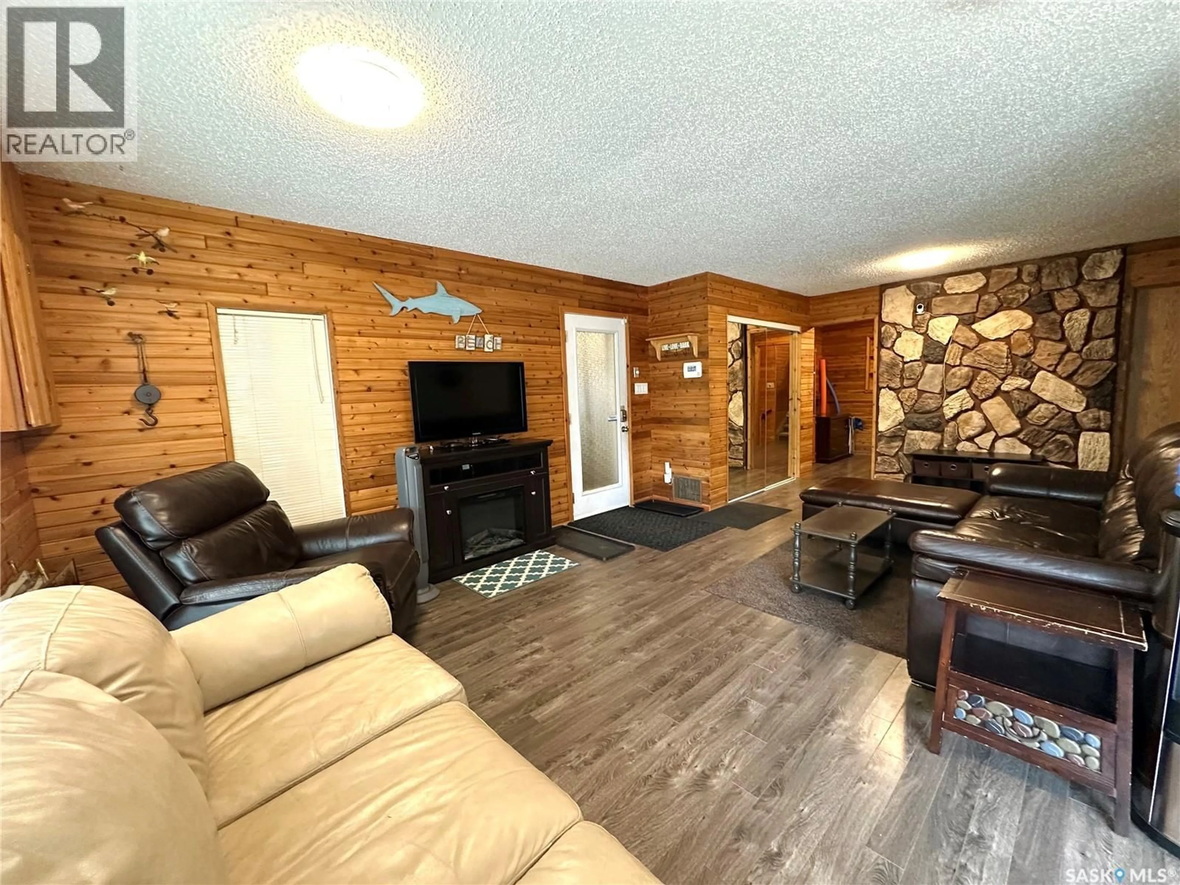 Living room with furniture, wood/laminate floor for 213 LAKEVIEW AVENUE, Canwood Rm No. 494 Saskatchewan S0J2X0