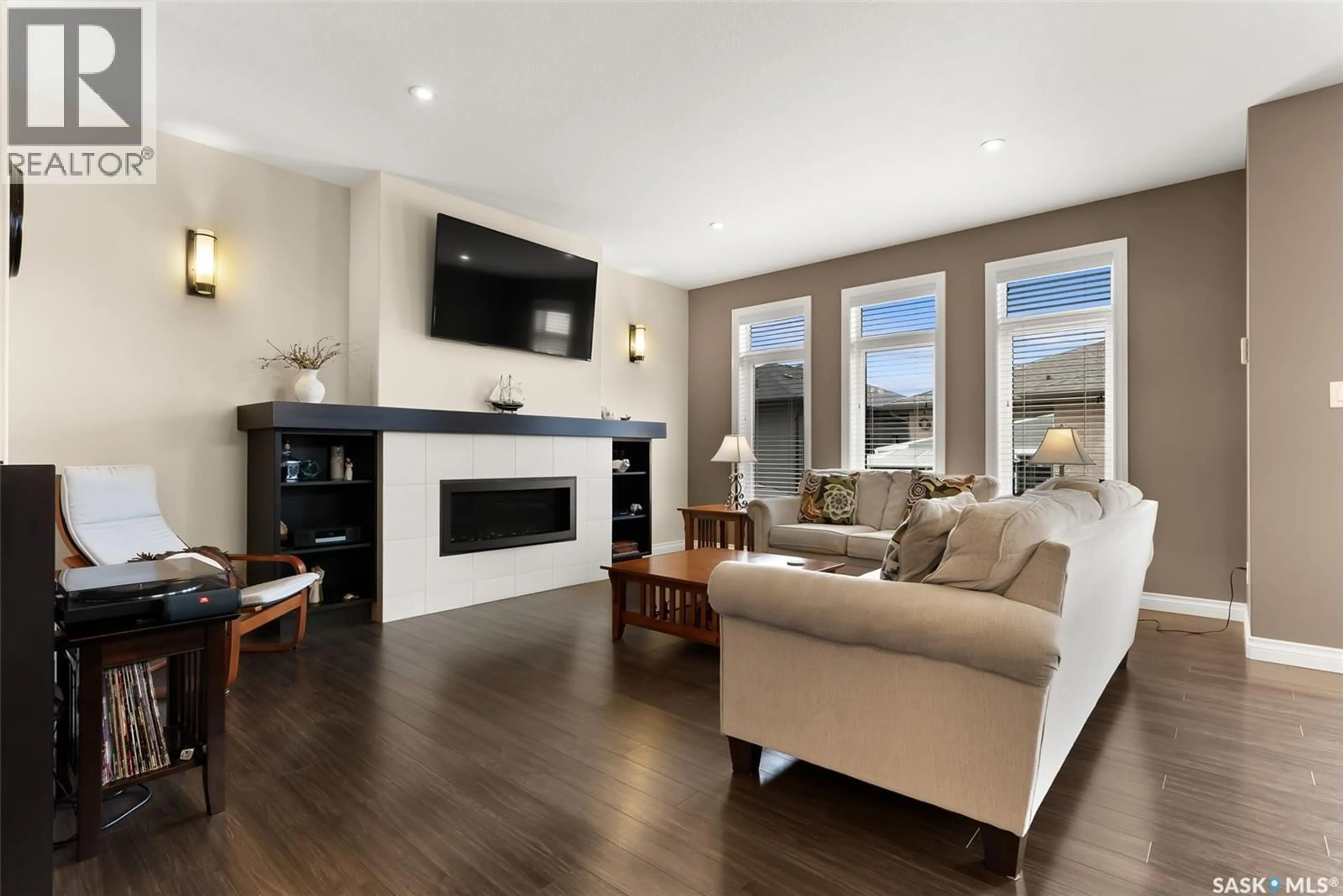 Living room with furniture, wood/laminate floor for 3326 GREEN BROOK ROAD, Regina Saskatchewan S4V3K2