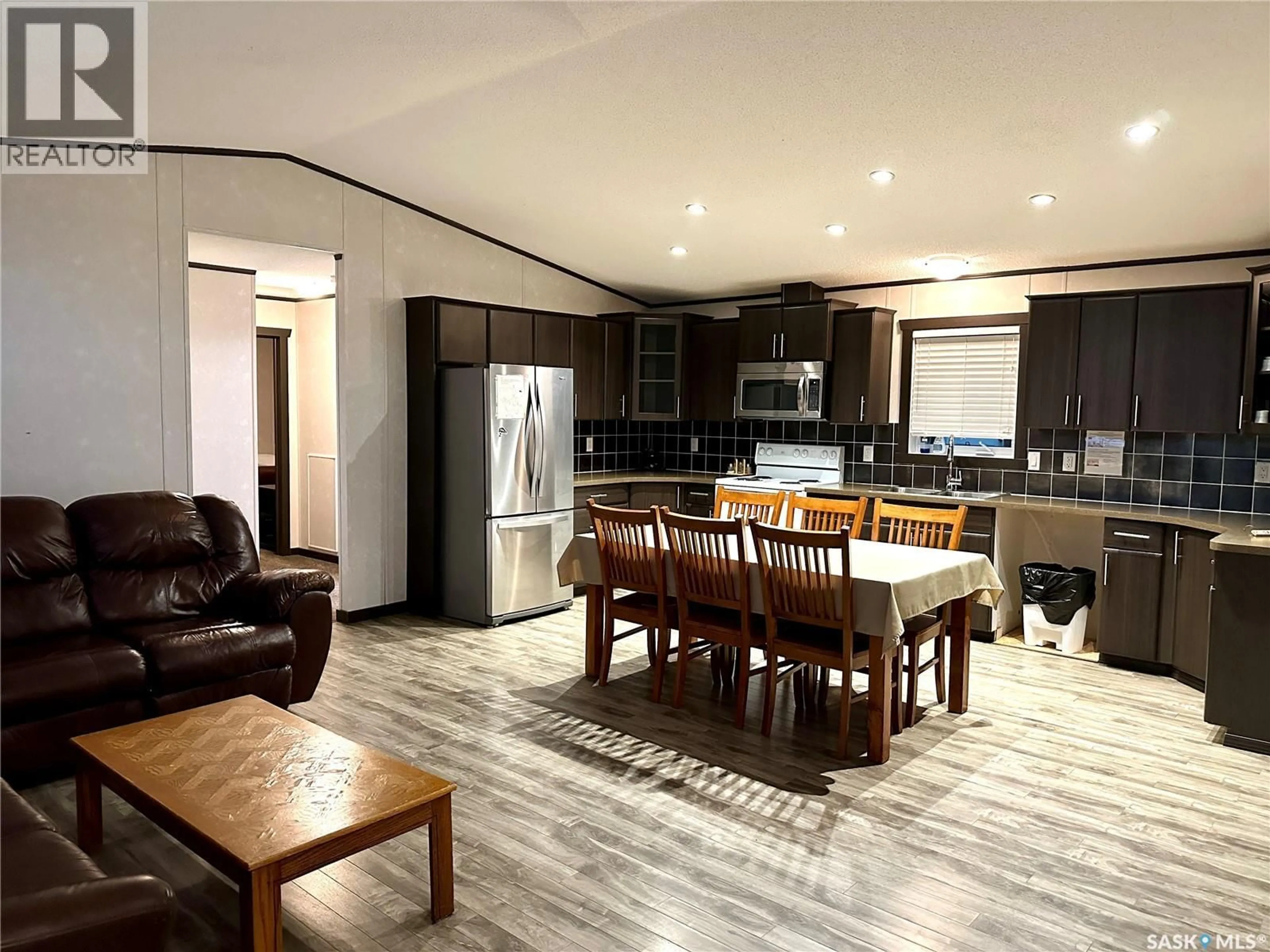 Open concept kitchen, wood/laminate floor for 903 OTTER STREET, Missinipe Saskatchewan S0J1L0
