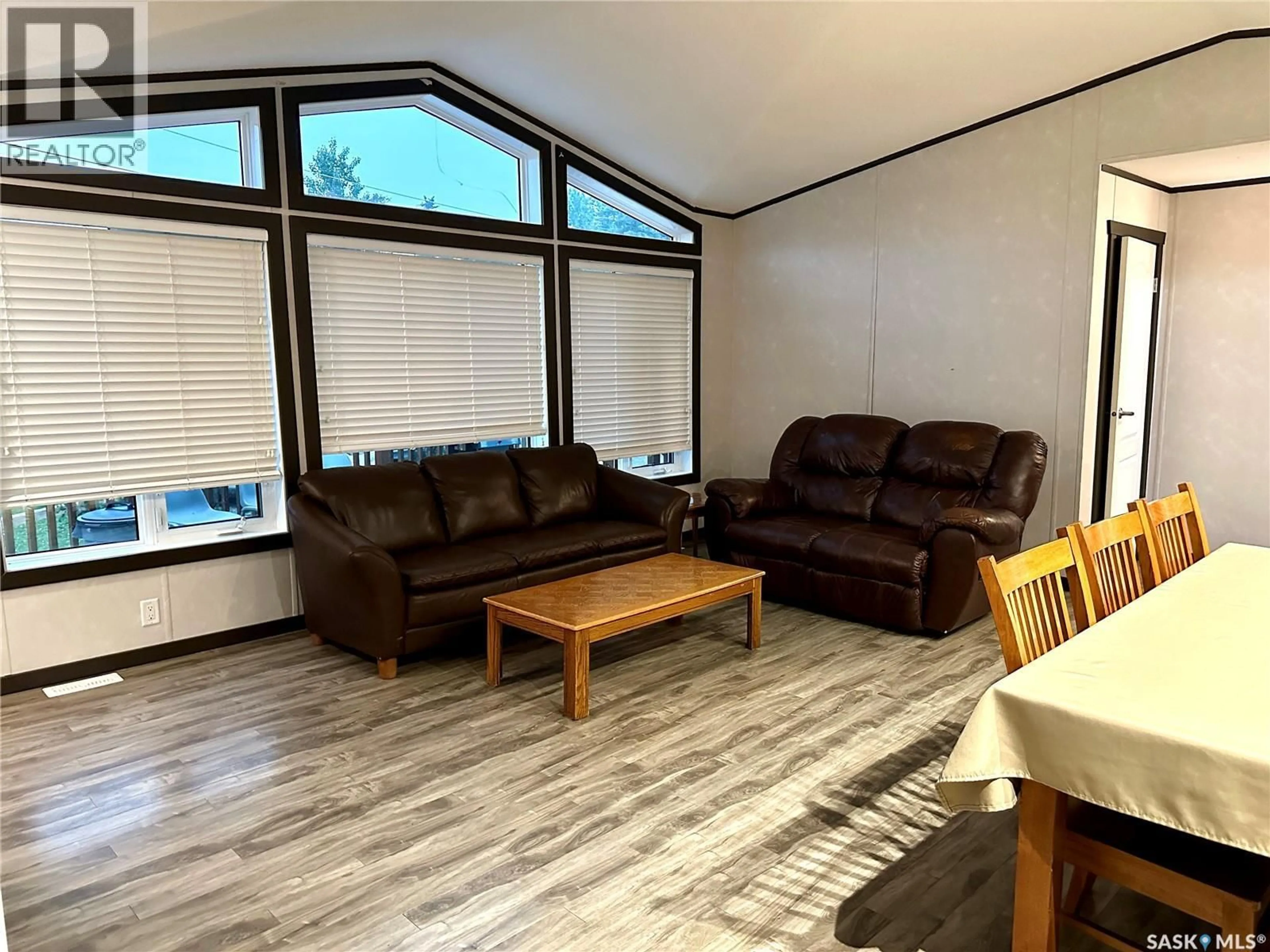 Living room with furniture, wood/laminate floor for 903 OTTER STREET, Missinipe Saskatchewan S0J1L0