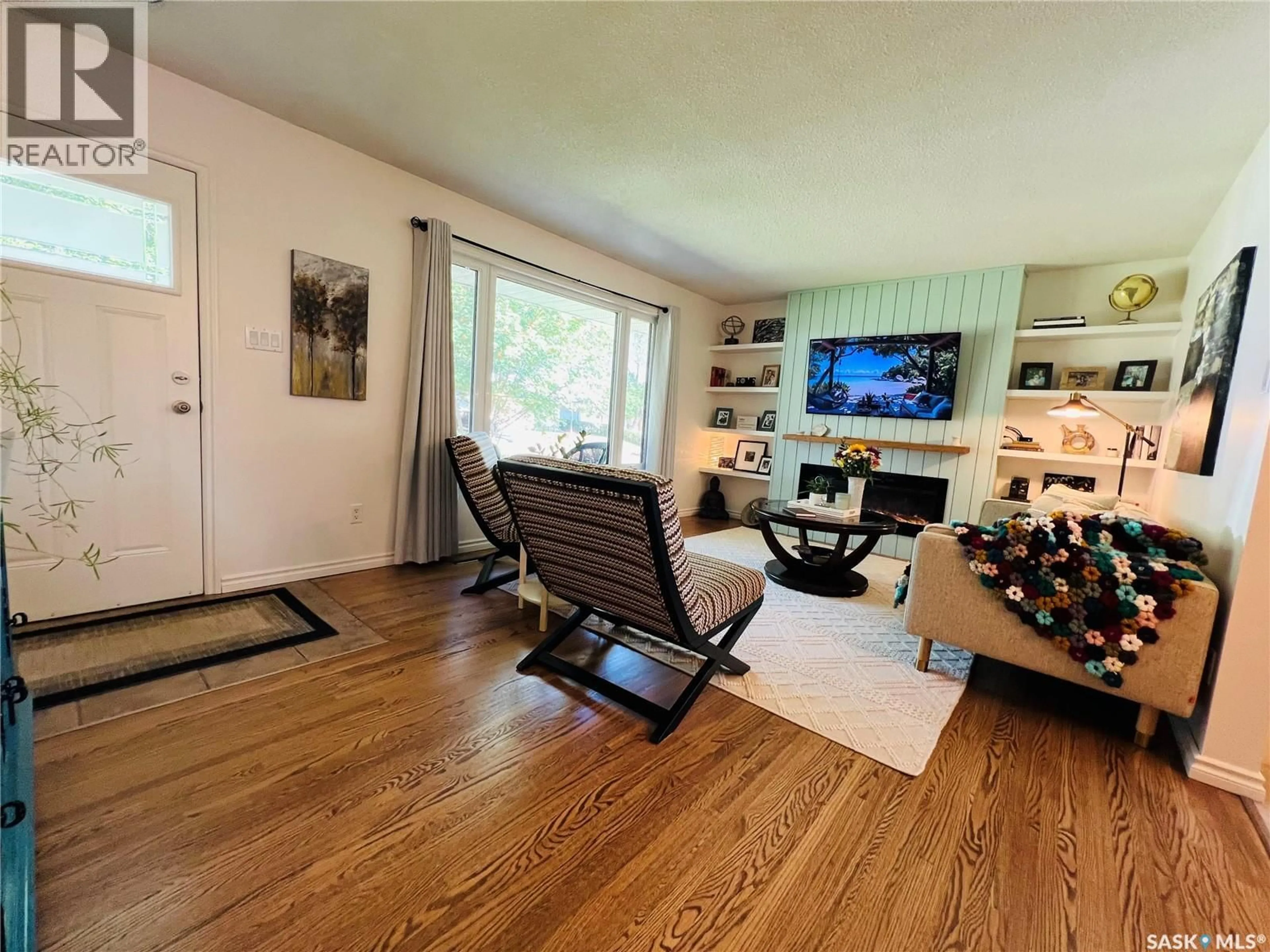 Living room with furniture, wood/laminate floor for 489 3RD AVENUE, Swift Current Saskatchewan S9H3K9