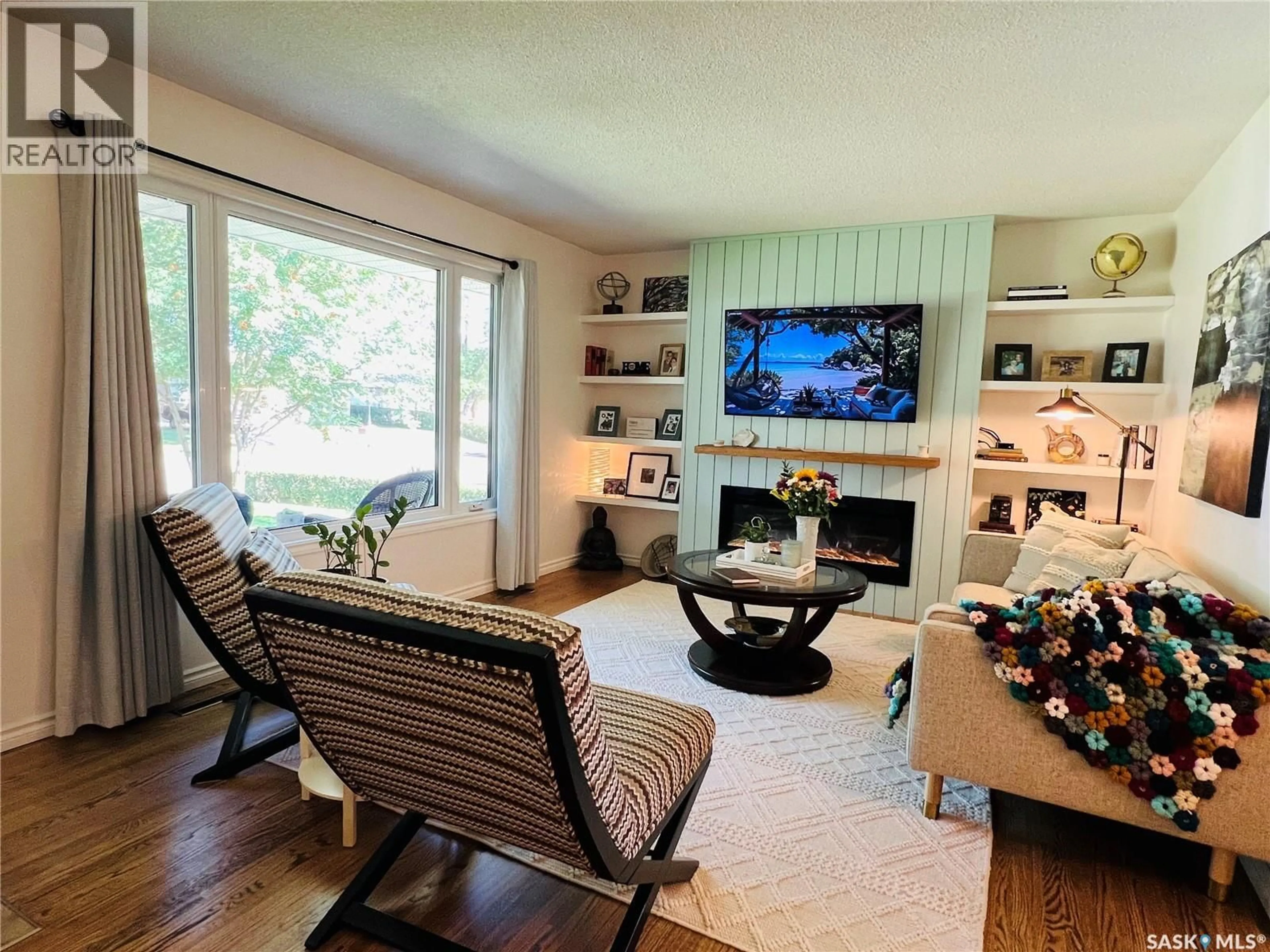 Living room with furniture, wood/laminate floor for 489 3RD AVENUE, Swift Current Saskatchewan S9H3K9
