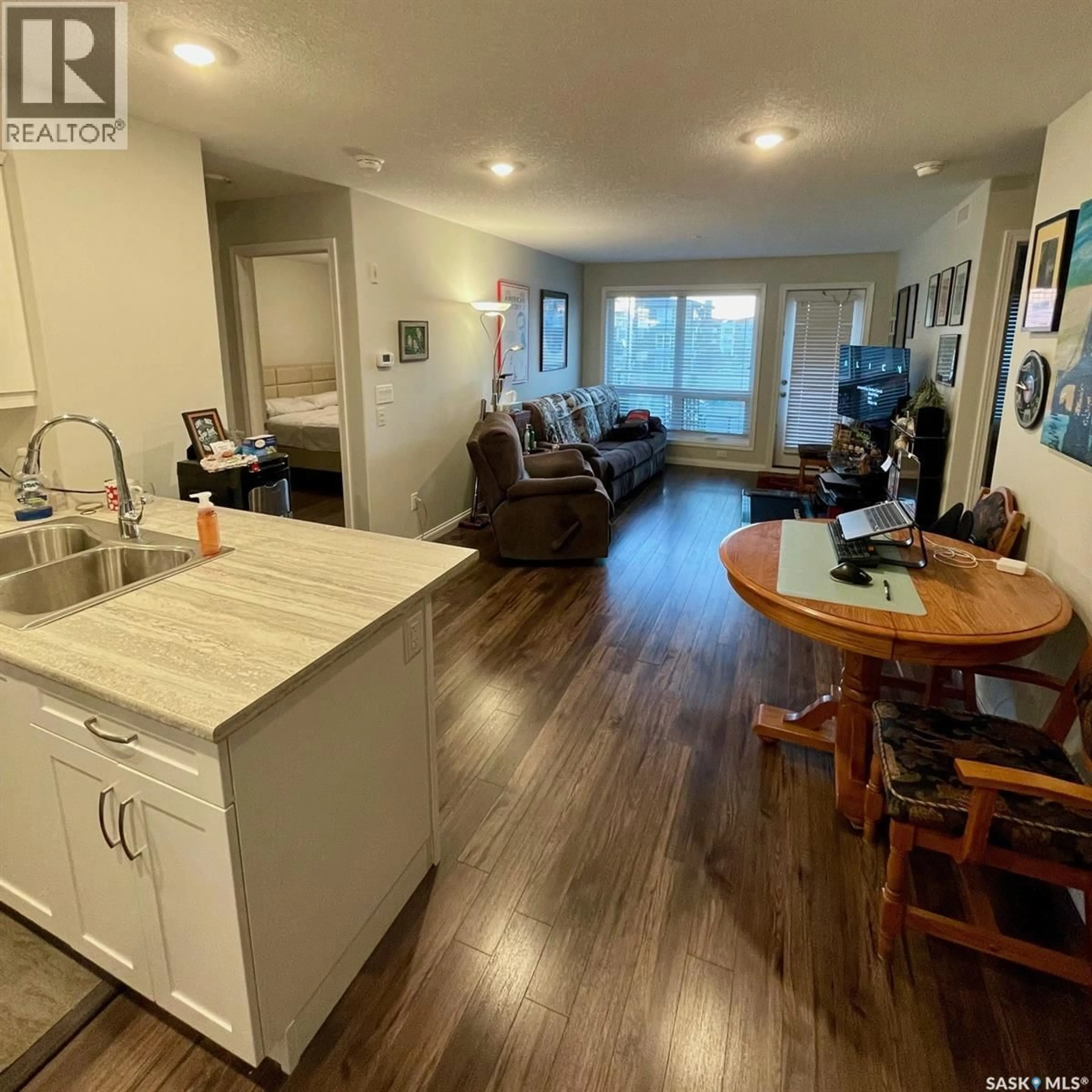 Open concept kitchen, wood/laminate floor for 106 - 3202 WILLIS CRESCENT, Saskatoon Saskatchewan S7T0T1