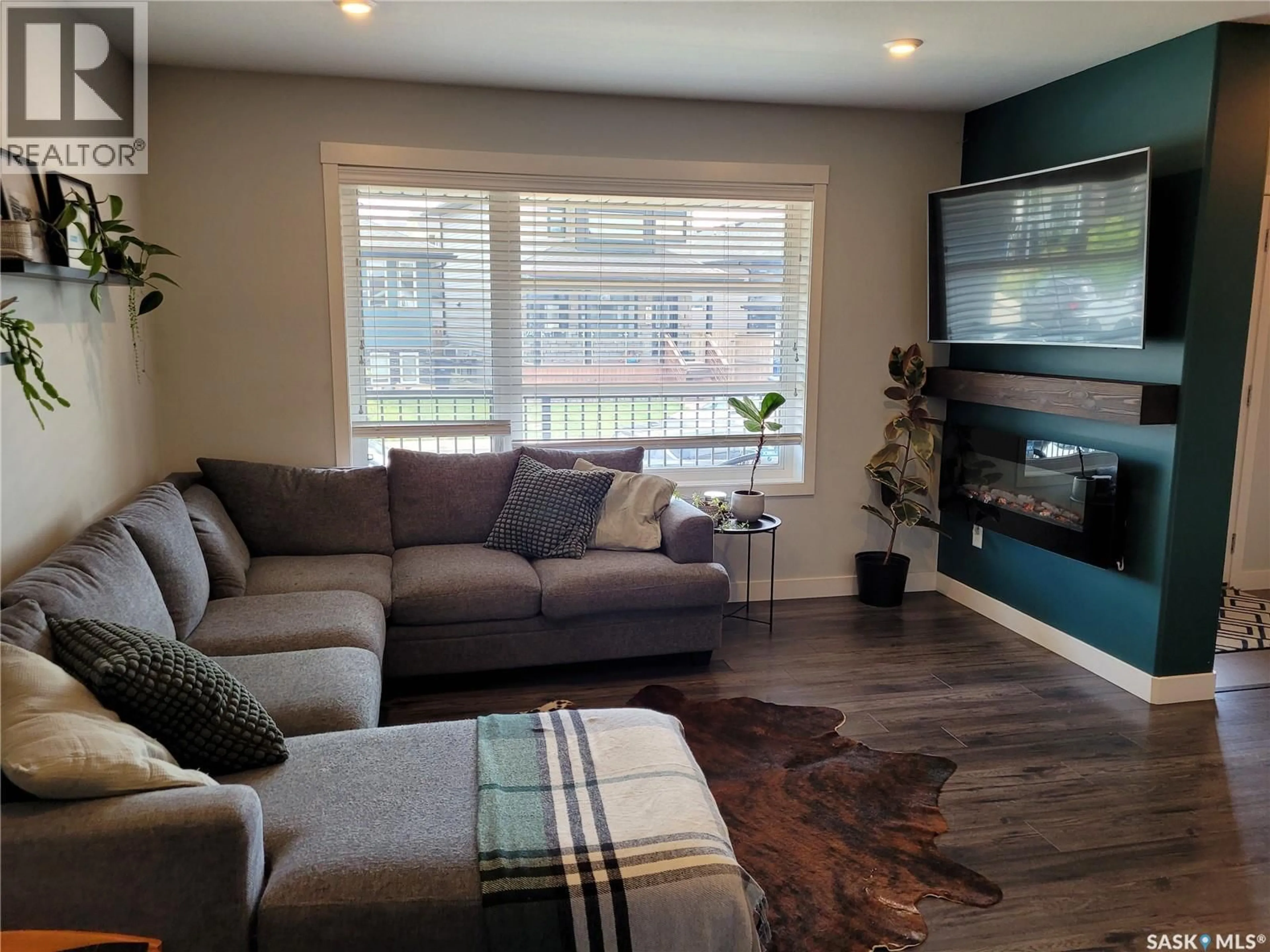 Living room with furniture, wood/laminate floor for 1054 KLOPPENBURG BEND, Saskatoon Saskatchewan S7W0P4