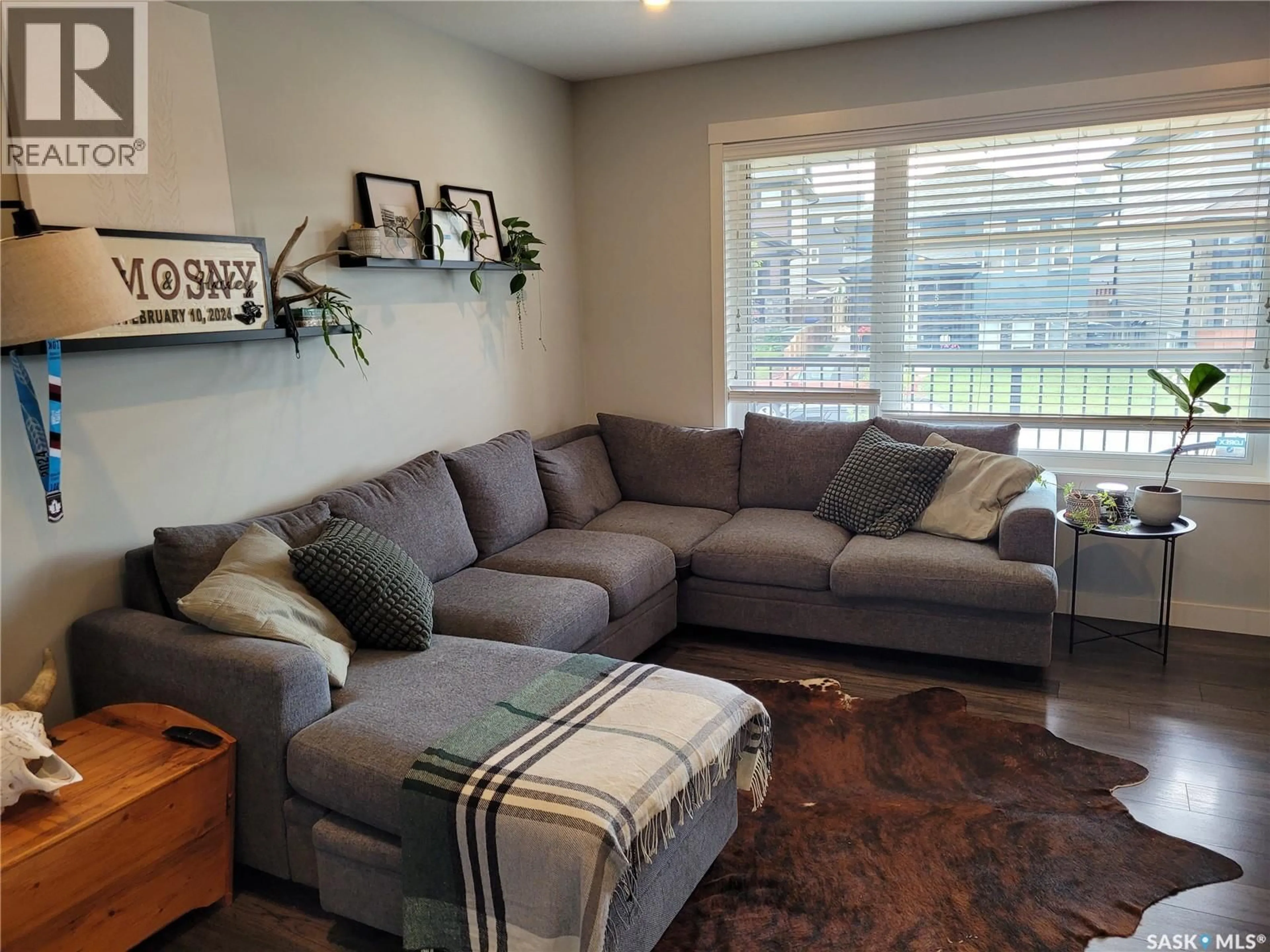 Living room with furniture, wood/laminate floor for 1054 KLOPPENBURG BEND, Saskatoon Saskatchewan S7W0P4