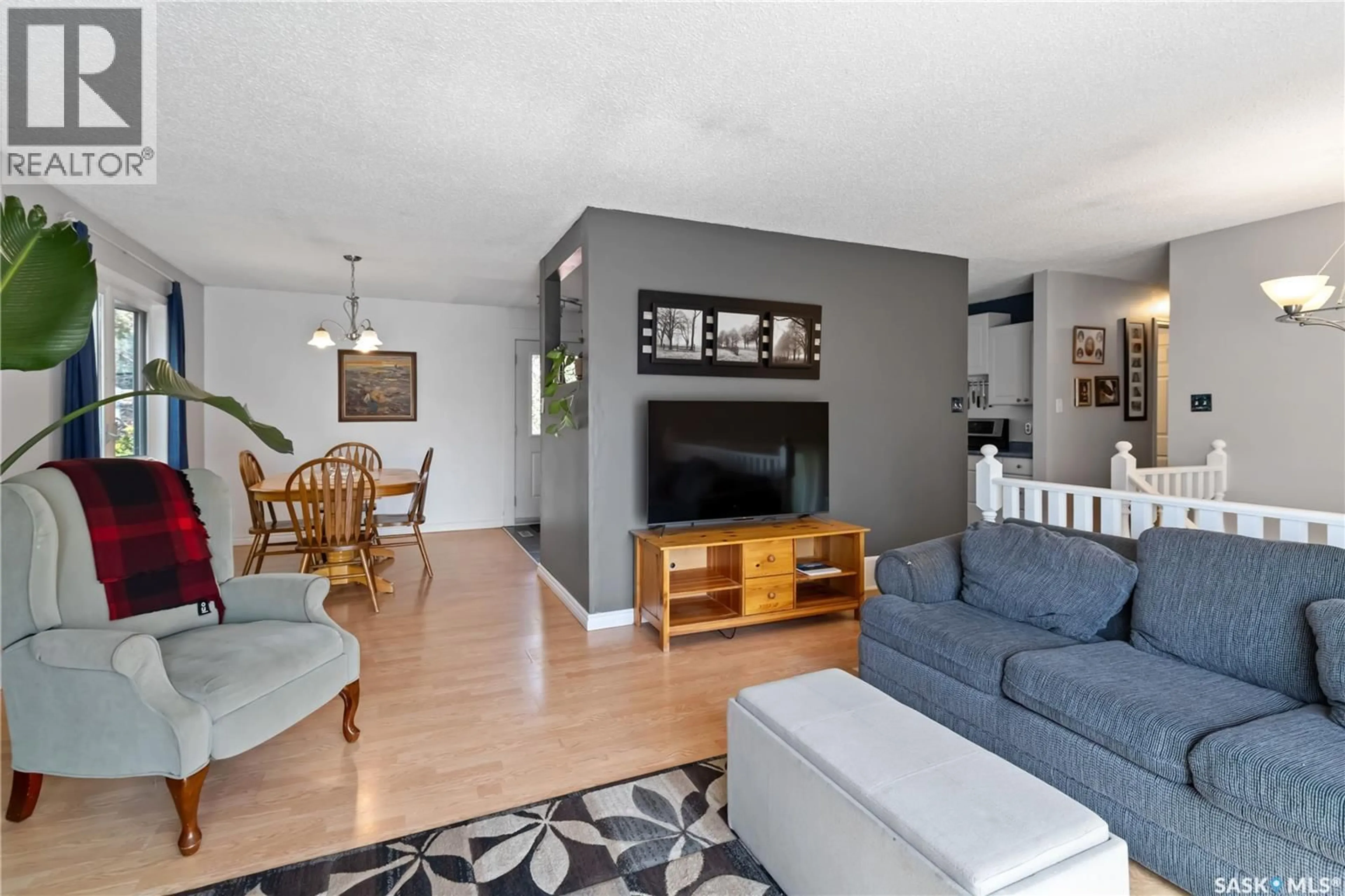 Living room with furniture, wood/laminate floor for 513 MCCORMACK ROAD, Saskatoon Saskatchewan S7M4Z6