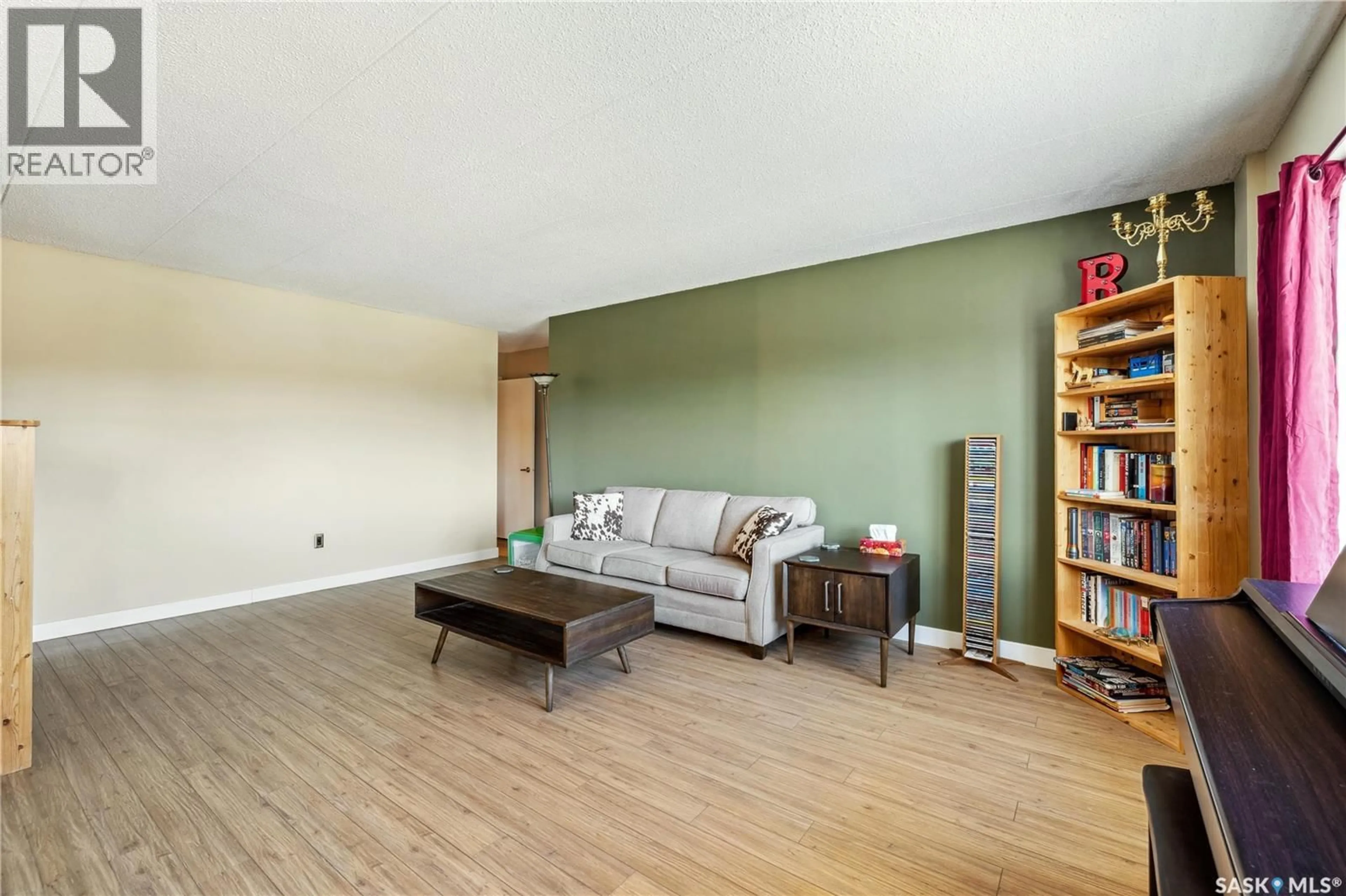 Living room with furniture, wood/laminate floor for 405 - 18 LORNE STREET, Regina Saskatchewan S4R3B2