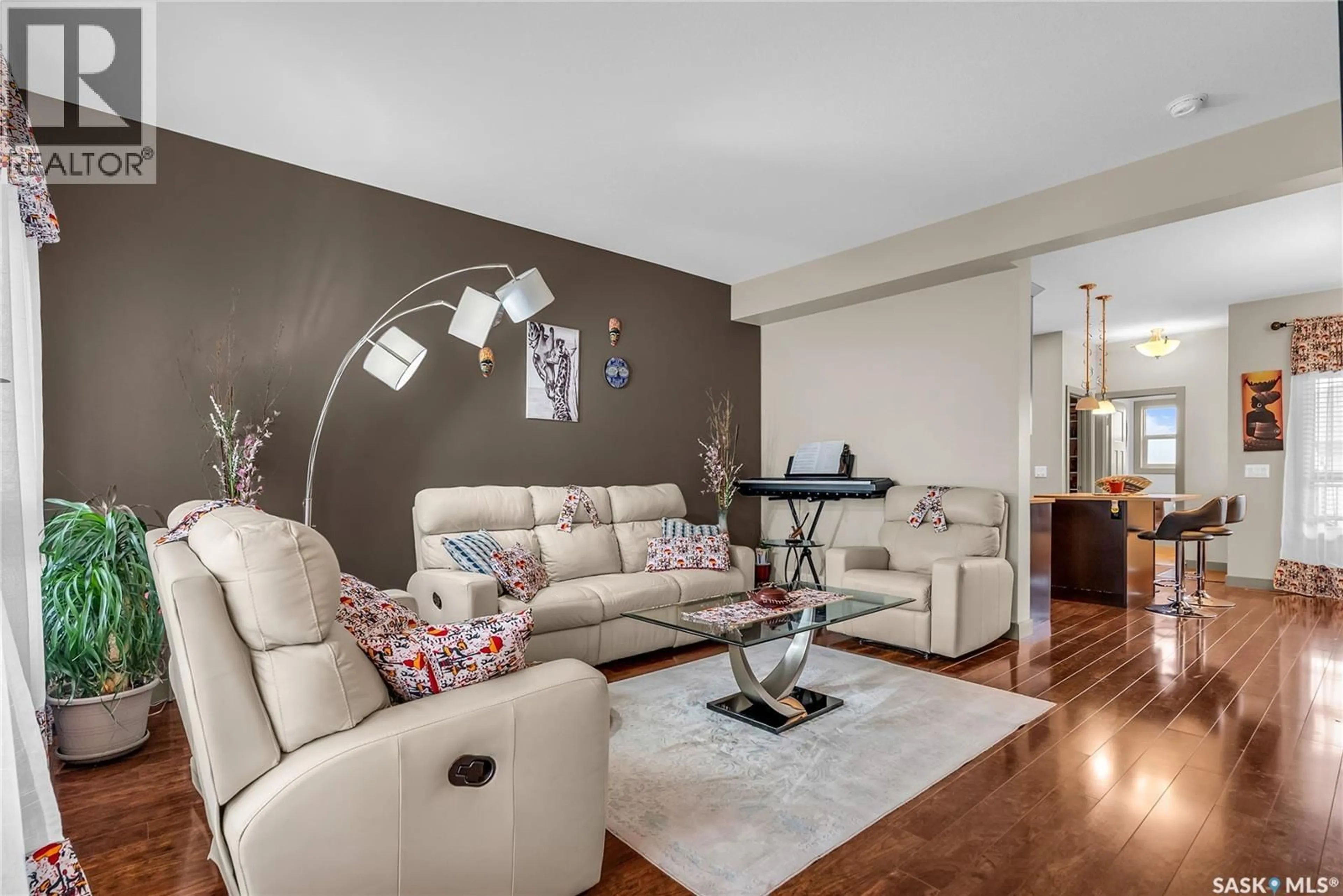 Living room with furniture, wood/laminate floor for 230 MANINGAS BEND, Saskatoon Saskatchewan S7P0A5