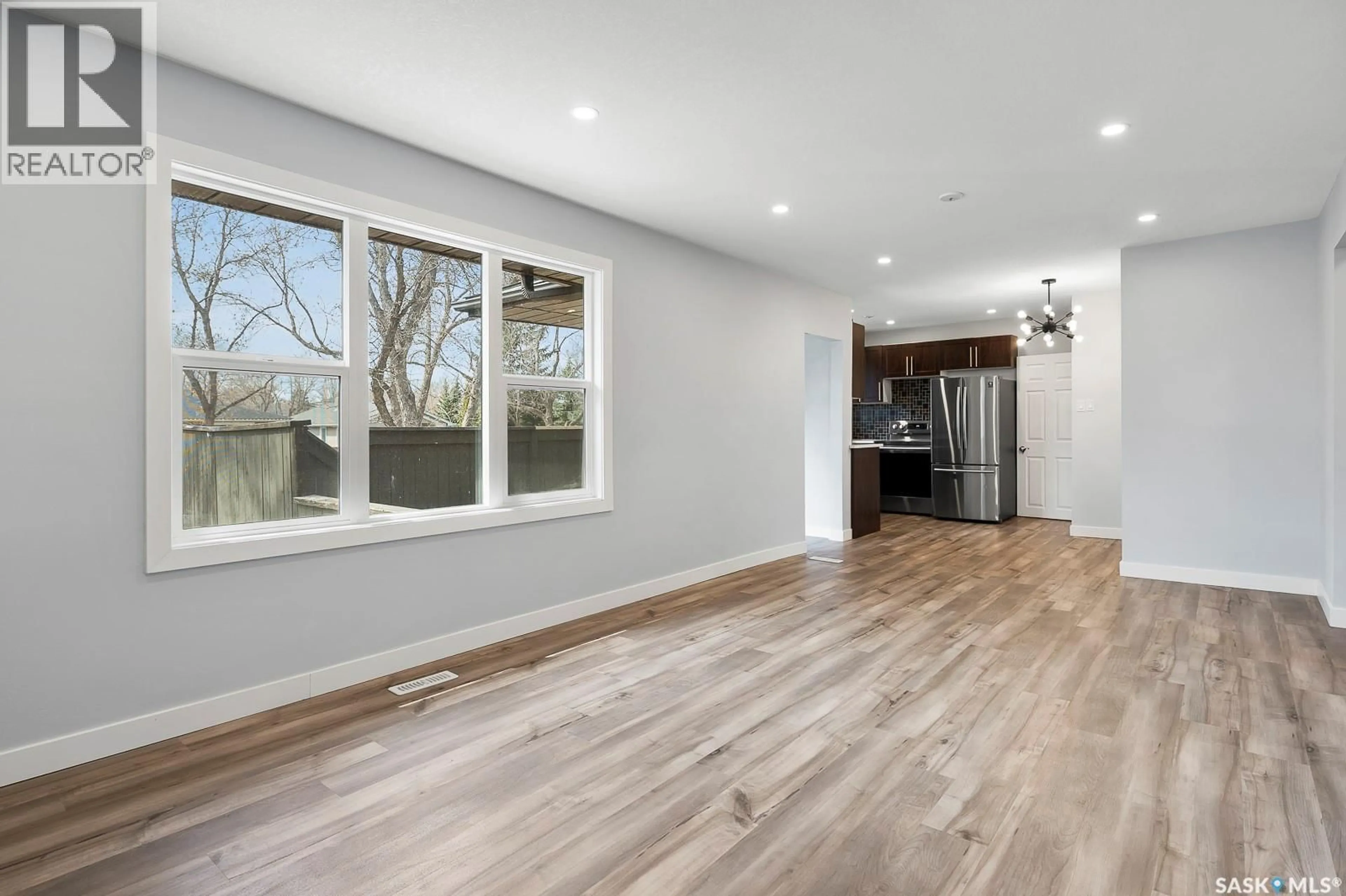 Open concept kitchen, wood/laminate floor for 2711 MACKAY STREET, Regina Saskatchewan S4N2T8