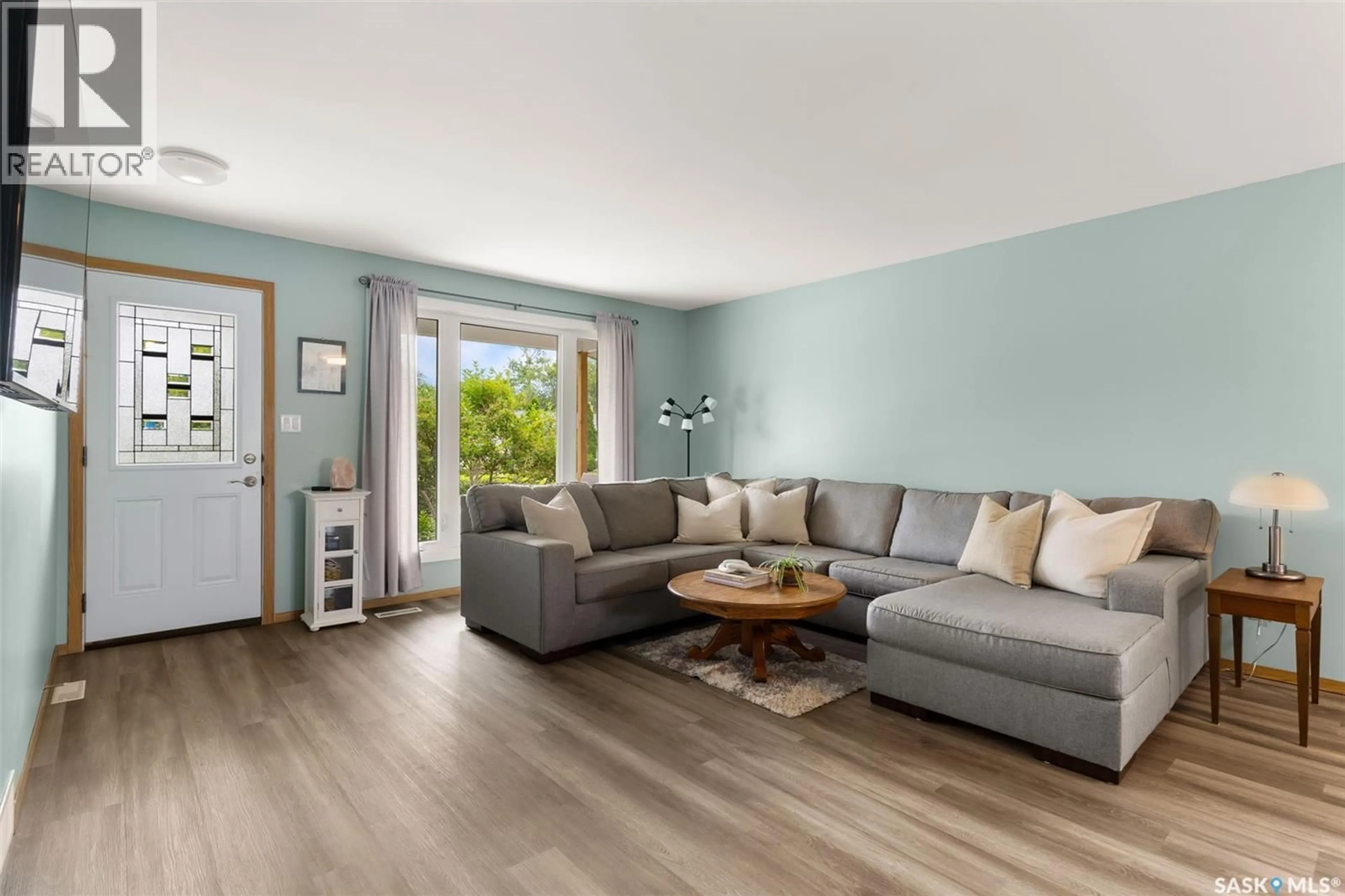 Living room with furniture, wood/laminate floor for 265 BROWNING STREET, Southey Saskatchewan S0G4P0