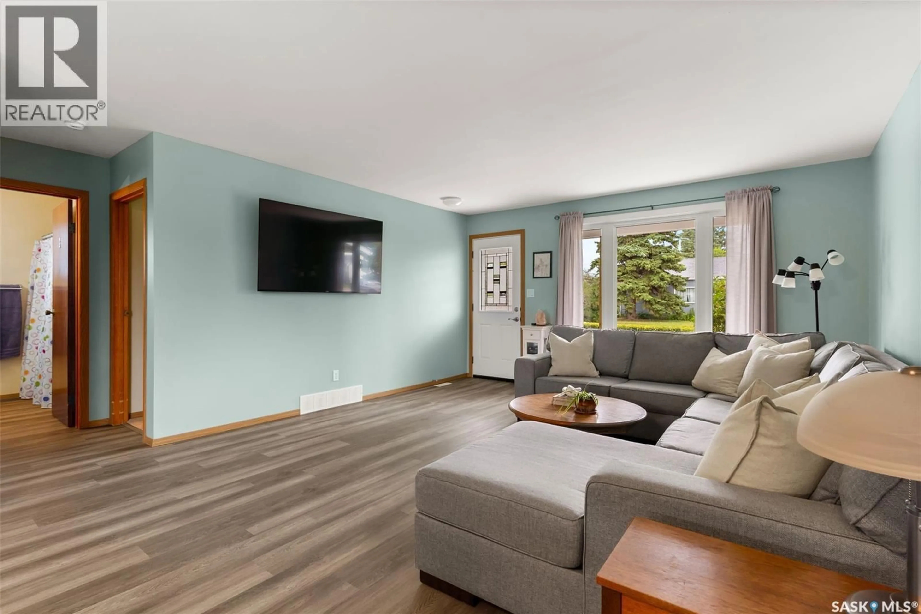 Living room with furniture, wood/laminate floor for 265 BROWNING STREET, Southey Saskatchewan S0G4P0