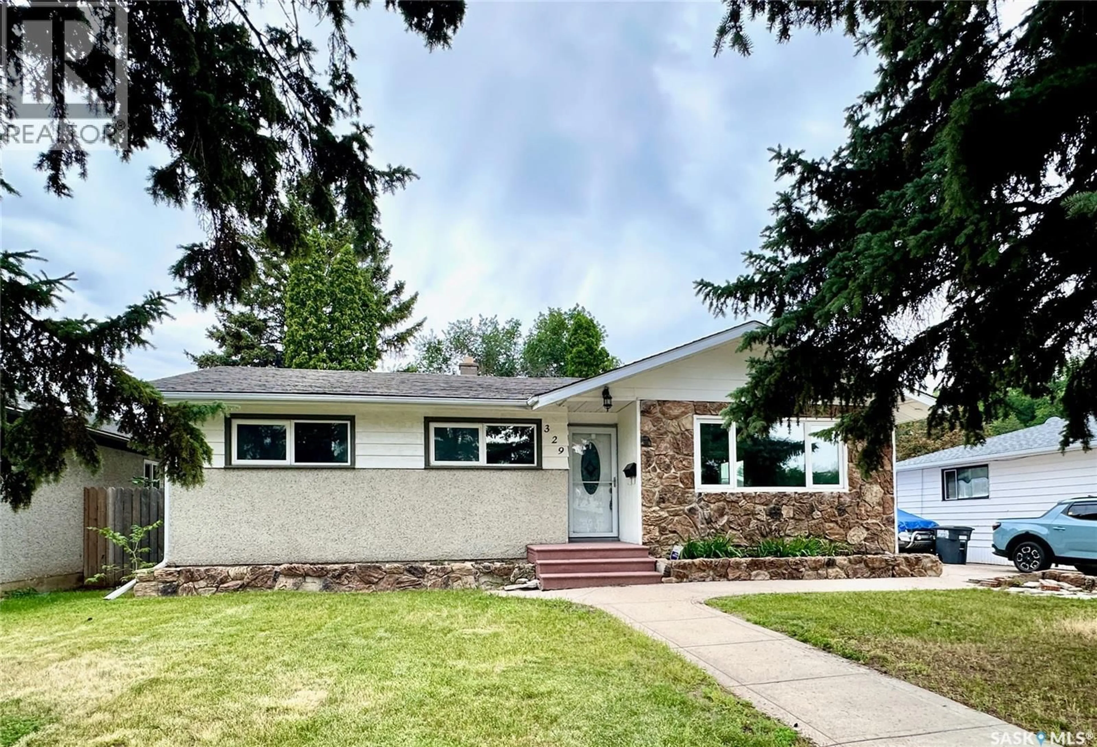 Home with vinyl exterior material, street for 329 Y AVENUE, Saskatoon Saskatchewan S7L3K8
