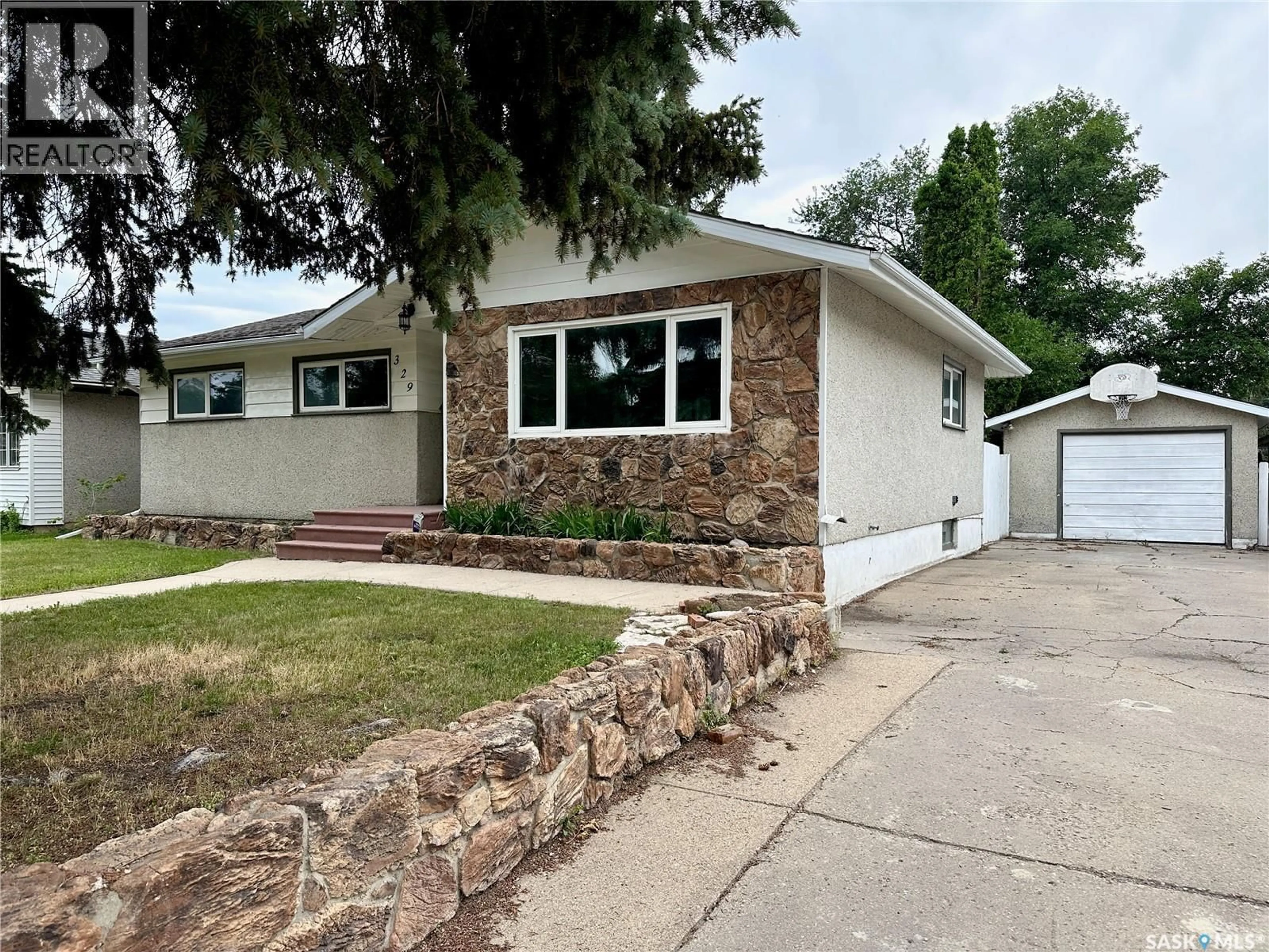 Home with vinyl exterior material, street for 329 Y AVENUE, Saskatoon Saskatchewan S7L3K8