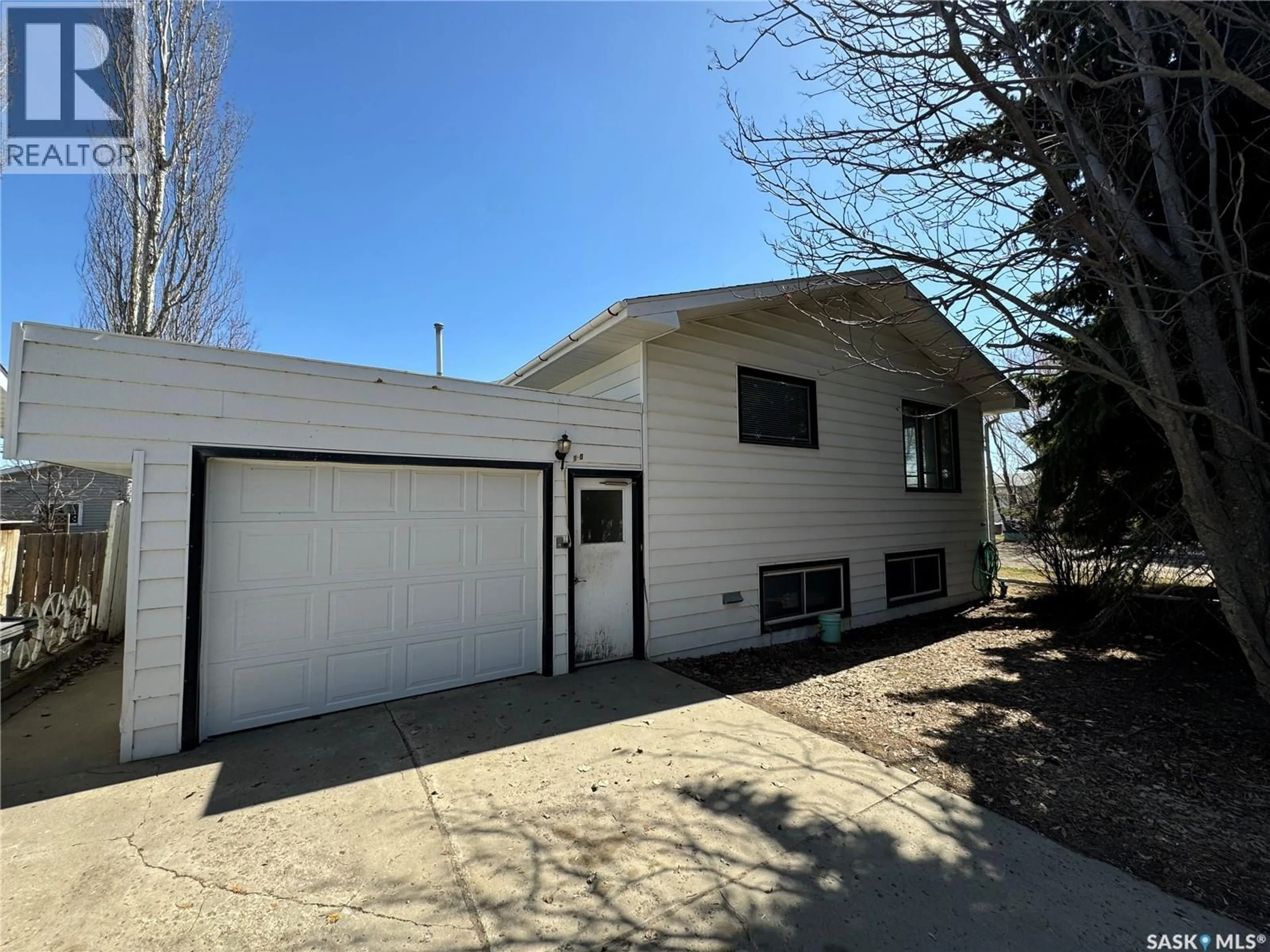 Home with vinyl exterior material, street for 803 1ST STREET, Humboldt Saskatchewan S0K2A0