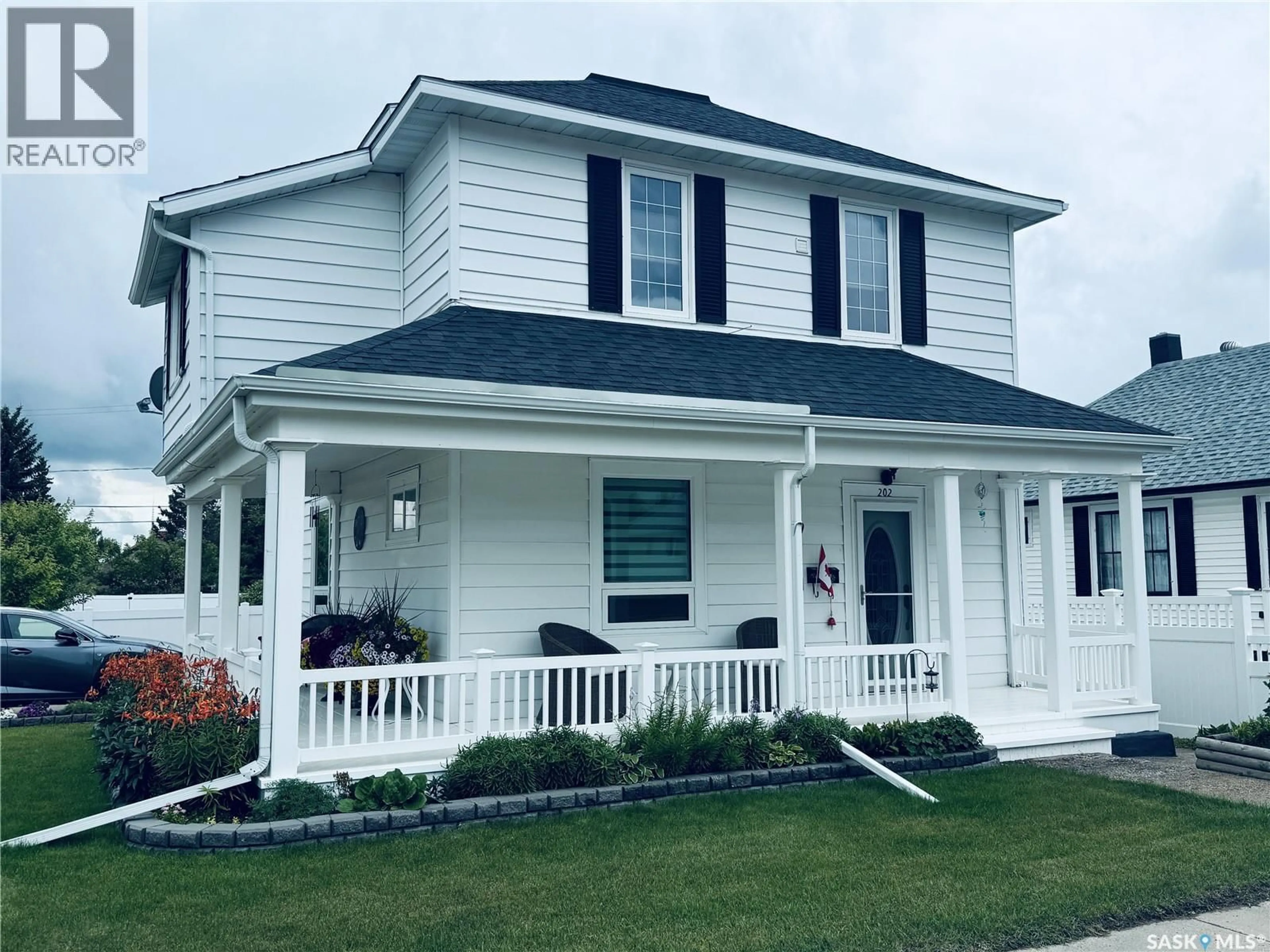 Home with vinyl exterior material, street for 202 5TH AVENUE, Biggar Saskatchewan S0K0M0