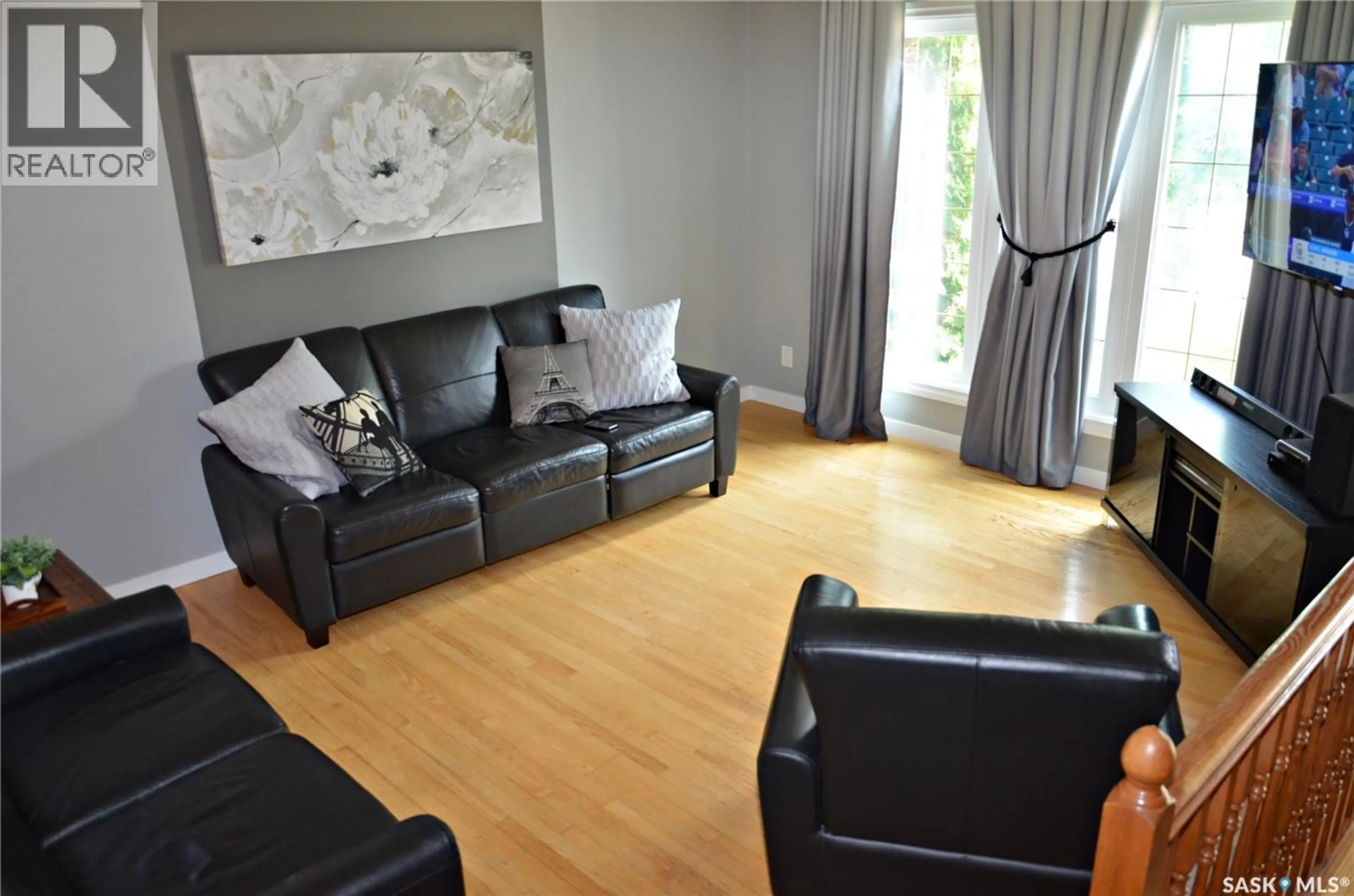 Living room with furniture, wood/laminate floor for 110 BRONSON CRESCENT, Saskatoon Saskatchewan S7J5C8