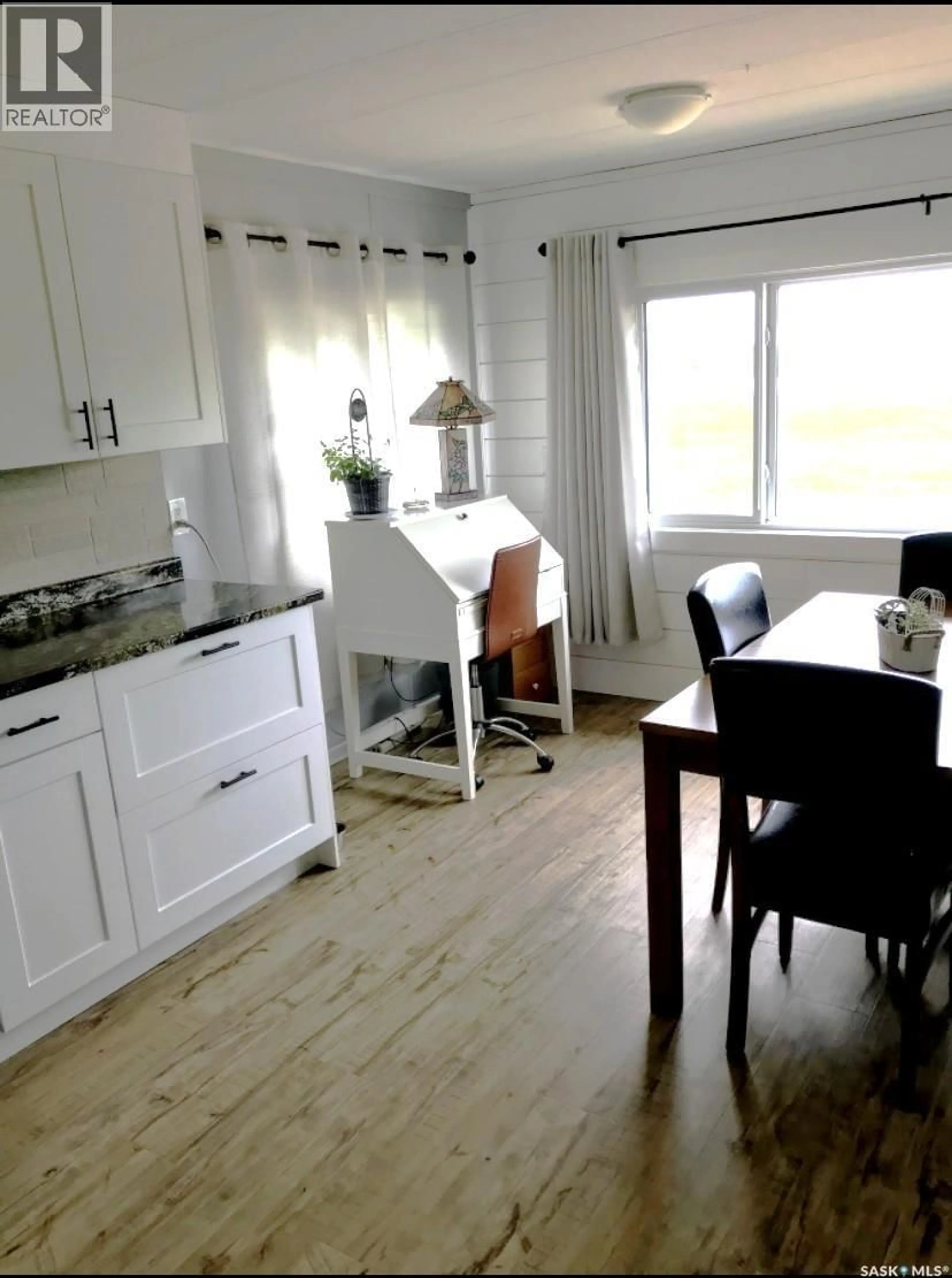 Open concept kitchen, wood/laminate floor for 11 401 RAILWAY AVENUE E, Vanscoy Saskatchewan S0L3J0