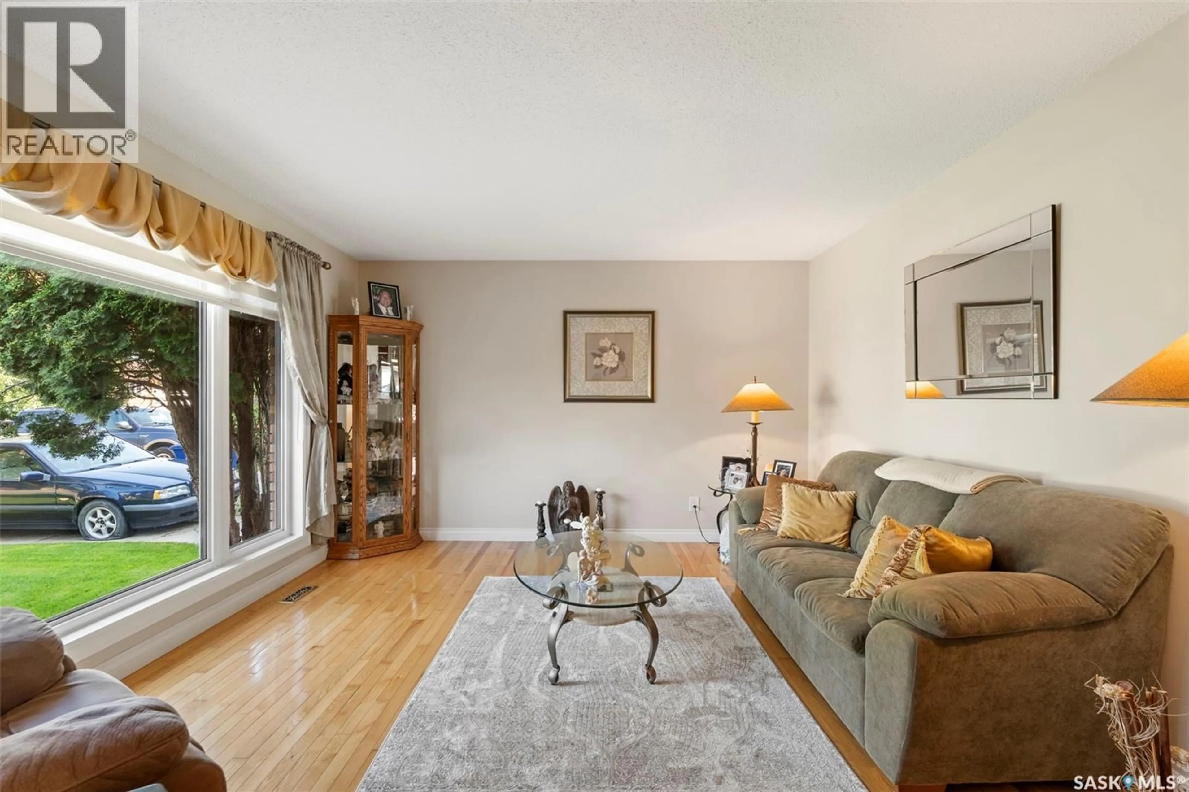 Living room with furniture, wood/laminate floor for 614 COSTIGAN WAY, Saskatoon Saskatchewan S7J3R2