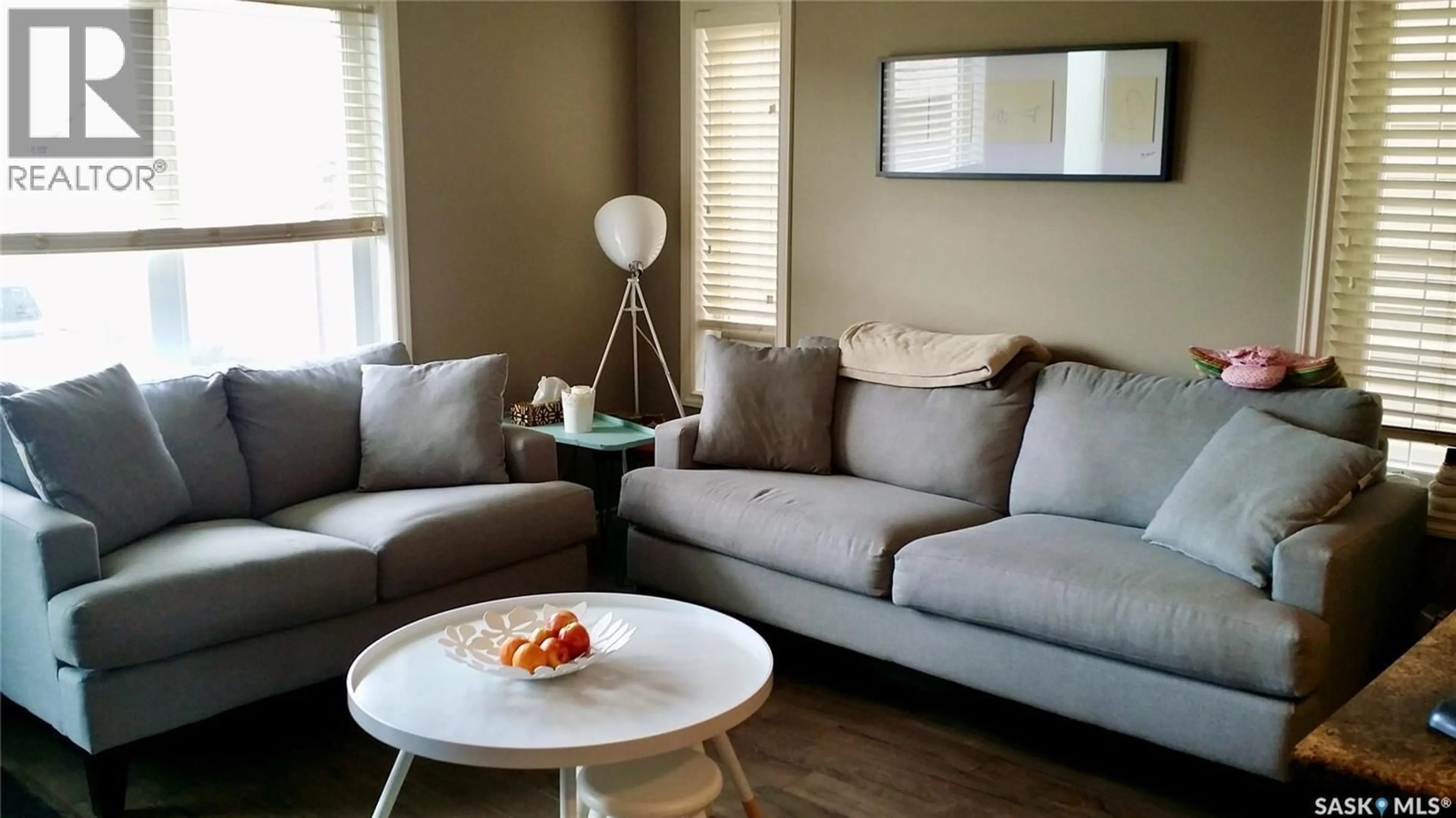 Living room with furniture, wood/laminate floor for 5406 MITCHINSON WAY, Regina Saskatchewan S4W0E7