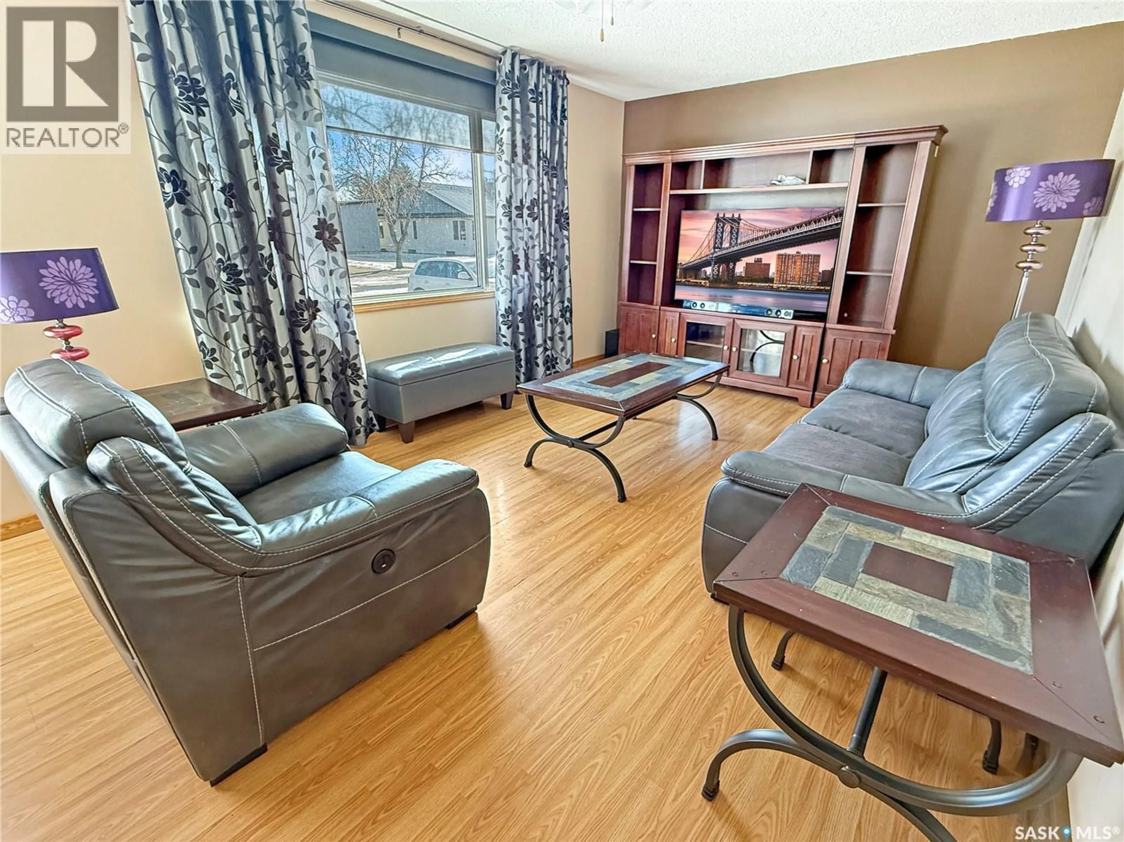 Living room with furniture, wood/laminate floor for 7466 LAKE AVENUE, Gull Lake Saskatchewan S0N1A0