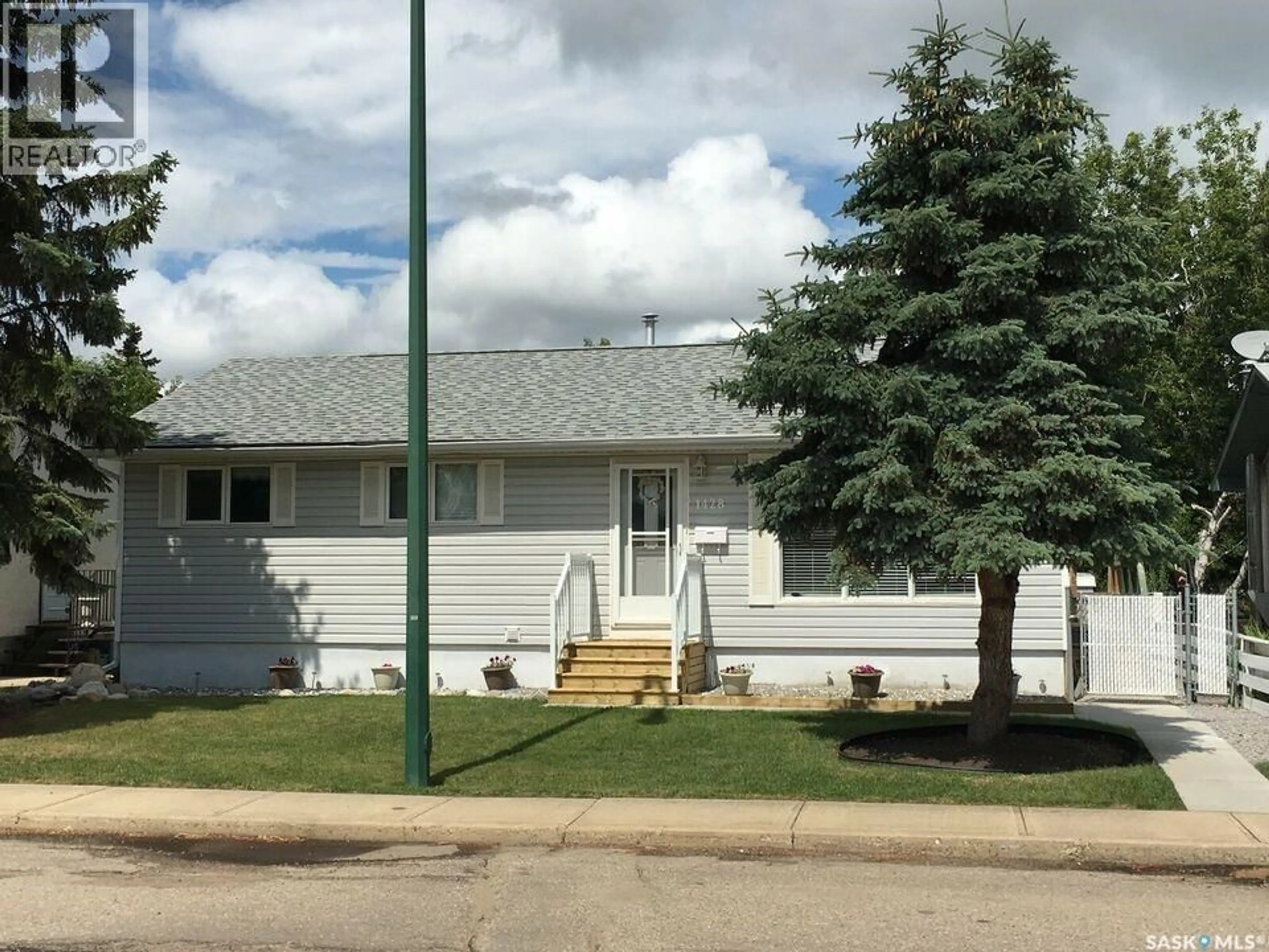 Home with vinyl exterior material, street for 1428 6TH STREET, Prince Albert Saskatchewan S6V0R3
