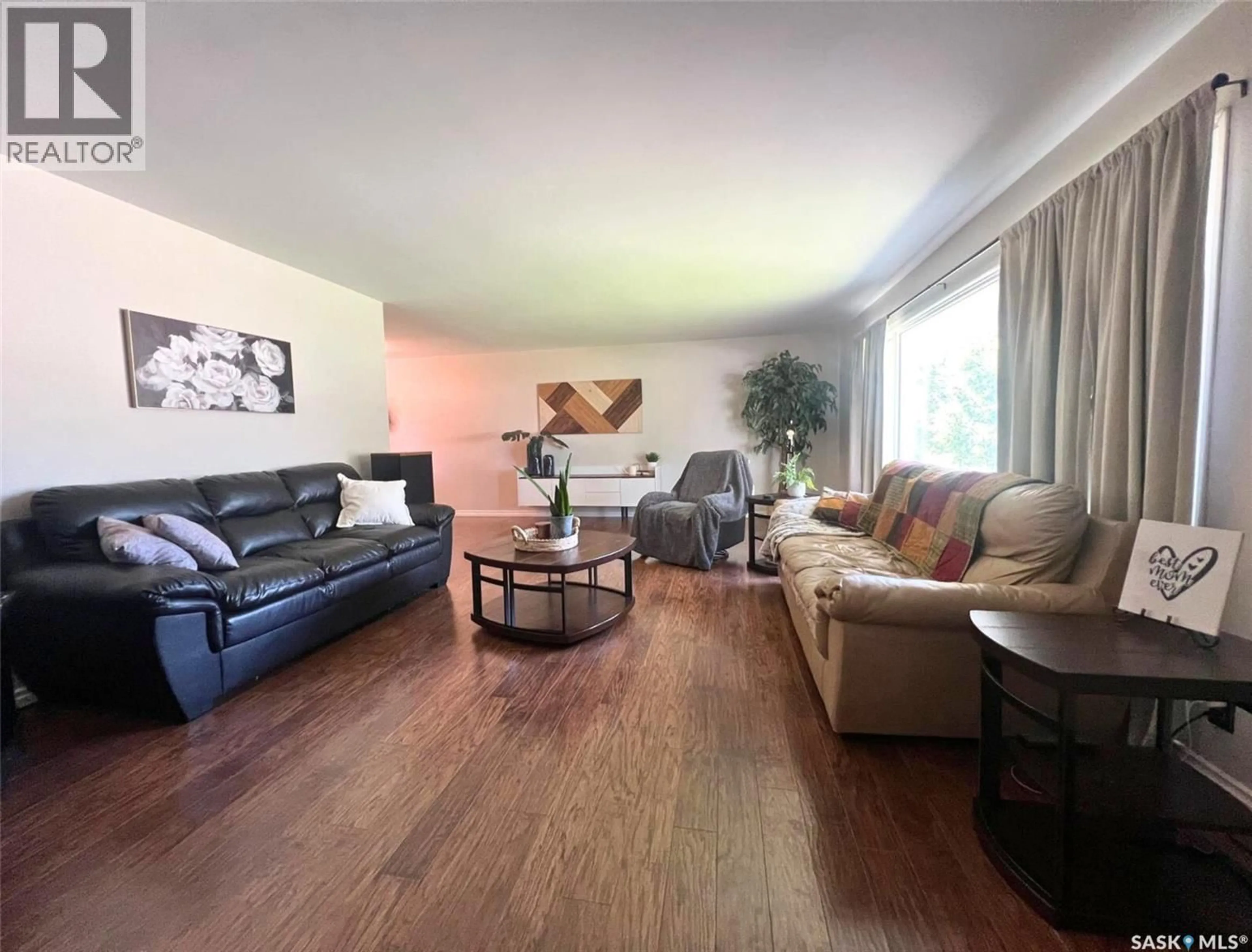 Living room with furniture, wood/laminate floor for 827 10TH AVENUE, Swift Current Saskatchewan S9H2T6