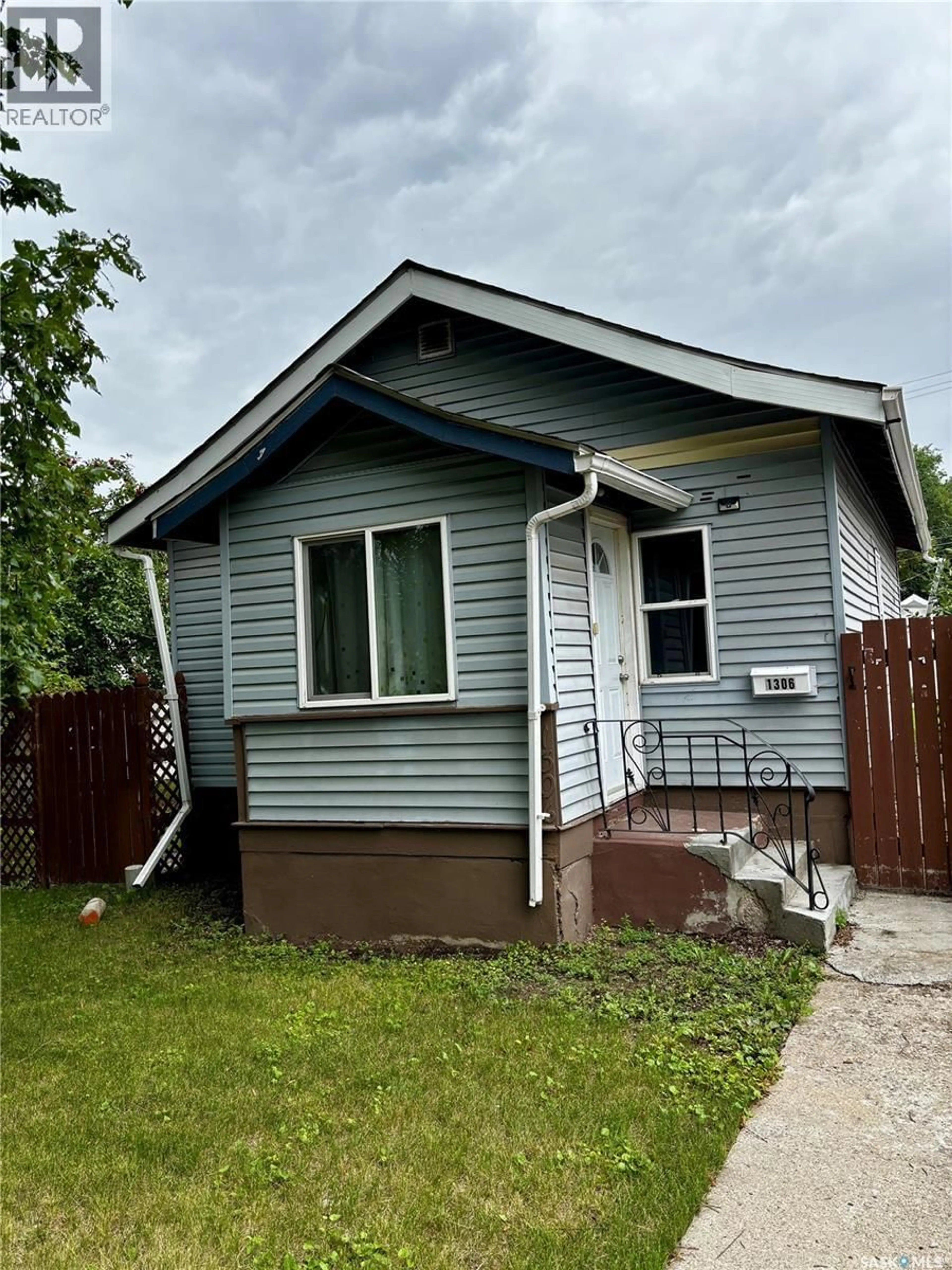 Home with vinyl exterior material, street for 1306 B AVENUE, Saskatoon Saskatchewan S7L1G5