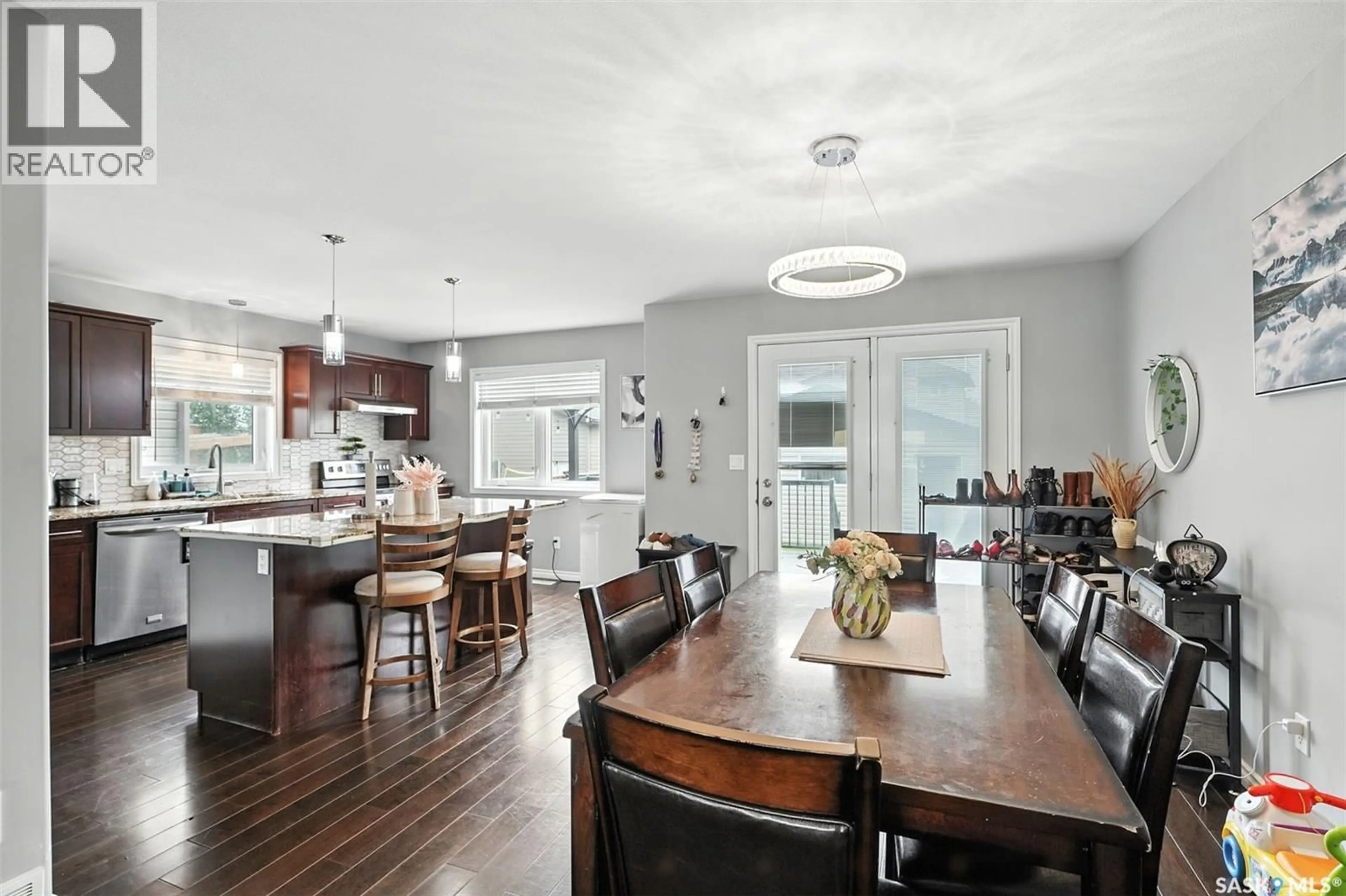 Open concept kitchen, wood/laminate floor for 166 CORNISH ROAD, Saskatoon Saskatchewan S7T0K4