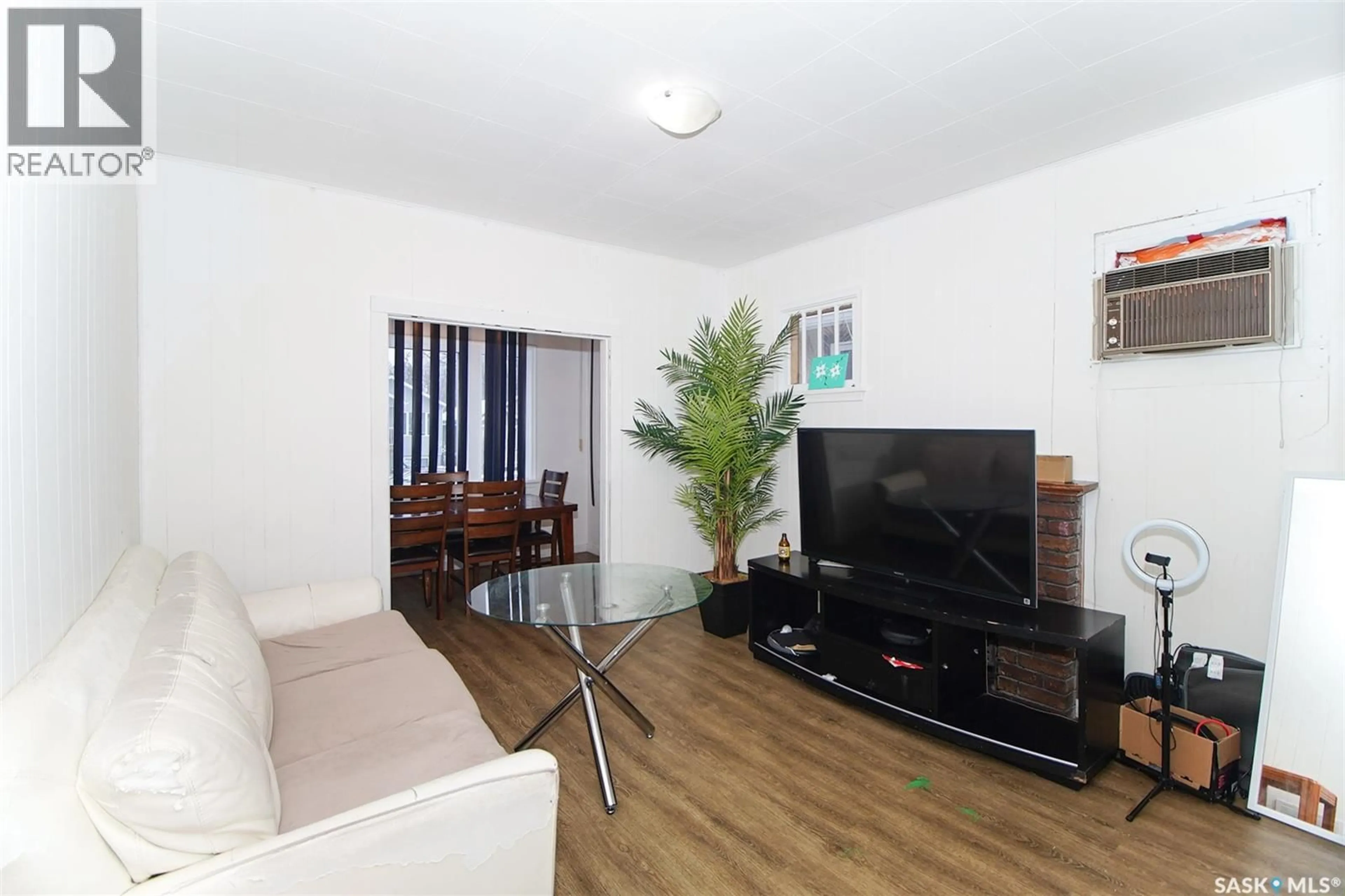 Living room with furniture, wood/laminate floor for 1428 QUEEN STREET, Regina Saskatchewan S4T4B8