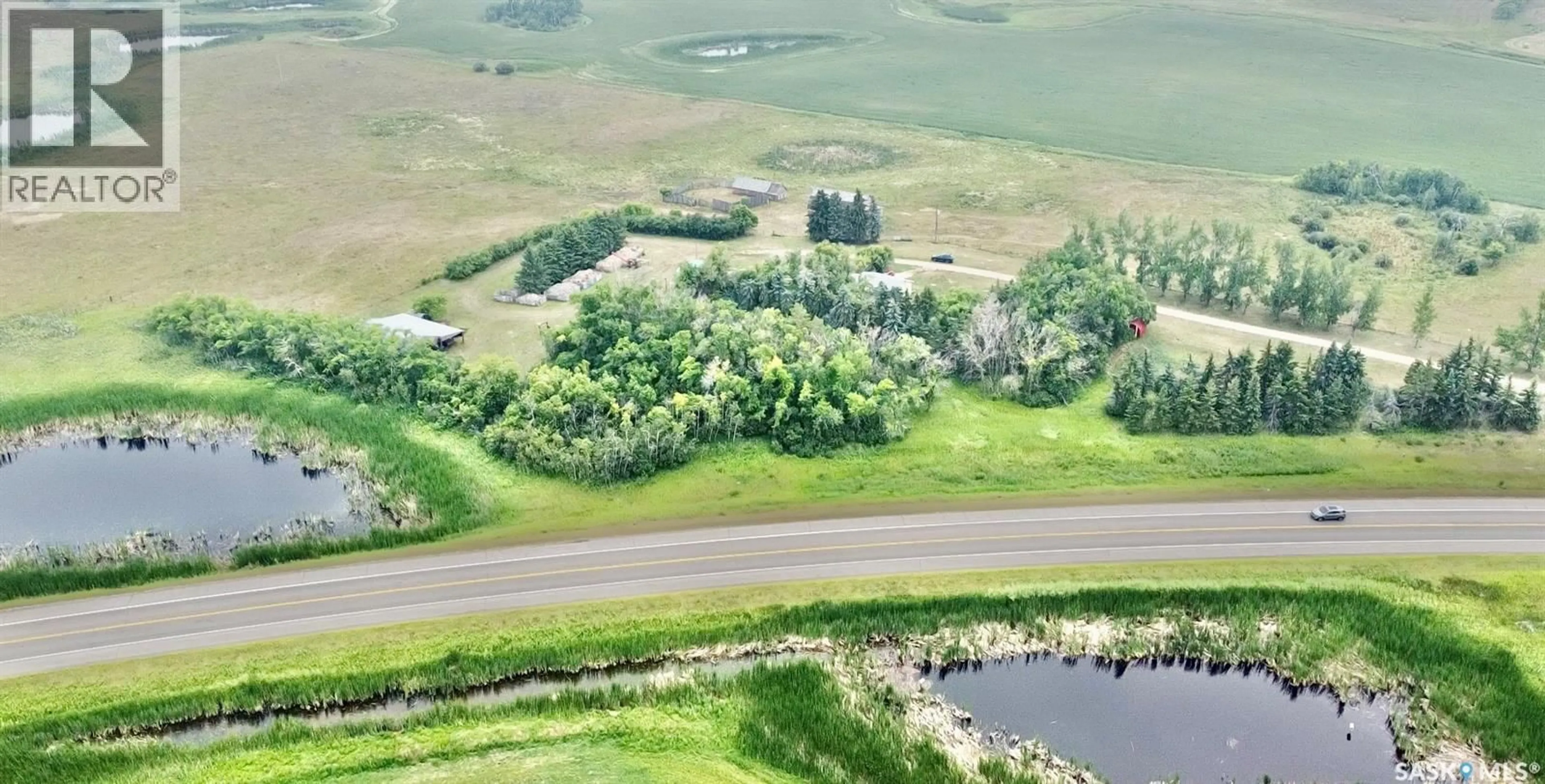 A pic from outside/outdoor area/front of a property/back of a property/a pic from drone, water/lake/river/ocean view for MELVILLE ACREAGE, Melville Saskatchewan S0A2P0
