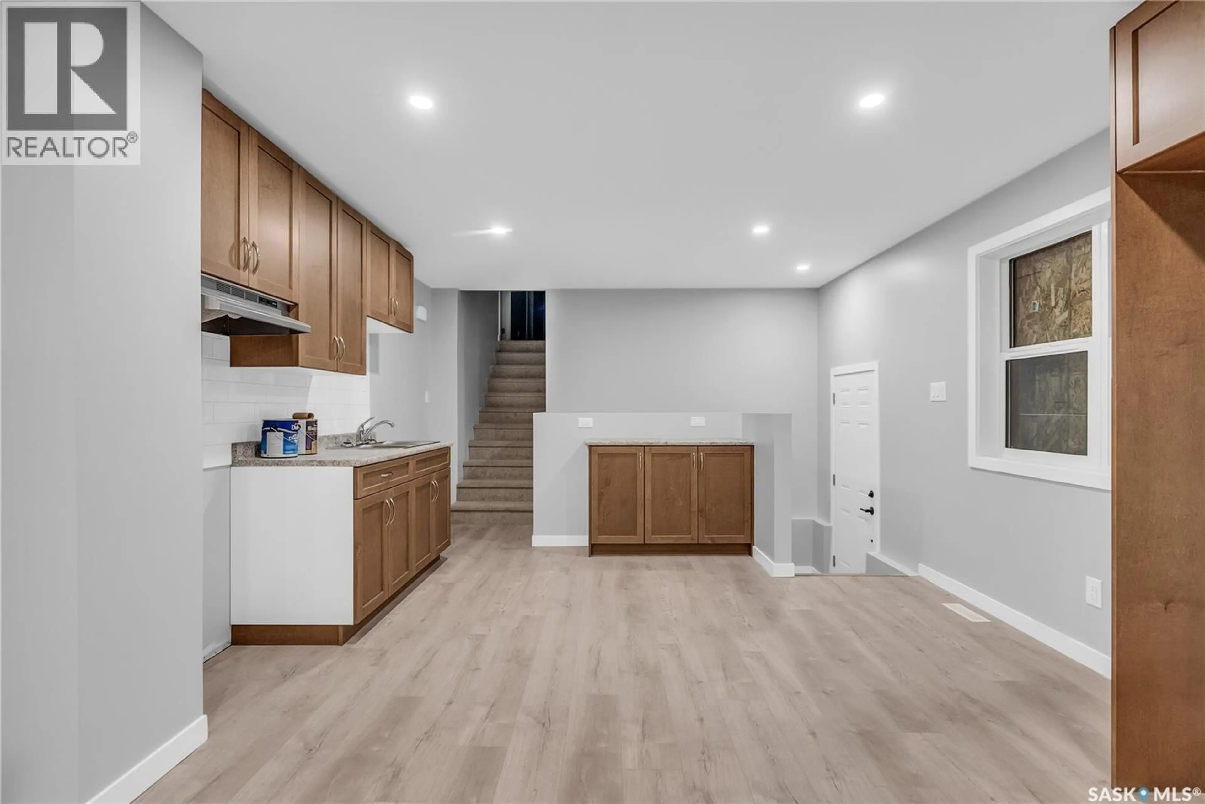 Open concept kitchen, wood/laminate floor for 228 S AVENUE S, Saskatoon Saskatchewan S7M2Z8