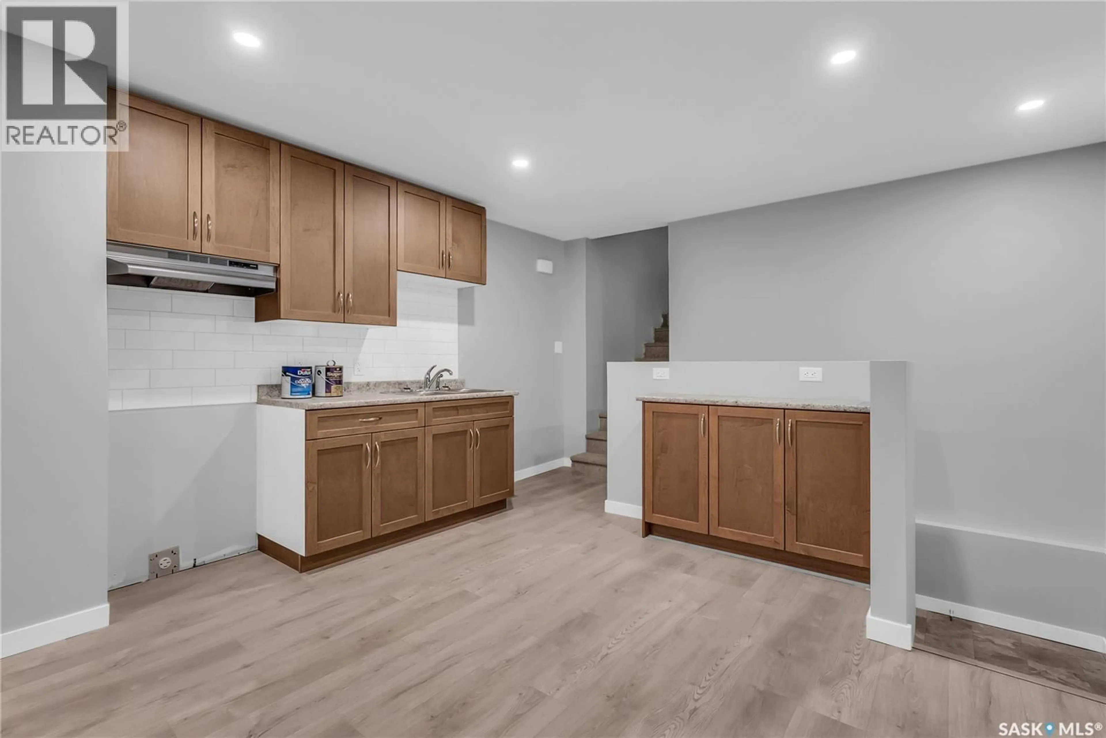 Open concept kitchen, wood/laminate floor for 228 S AVENUE S, Saskatoon Saskatchewan S7M2Z8