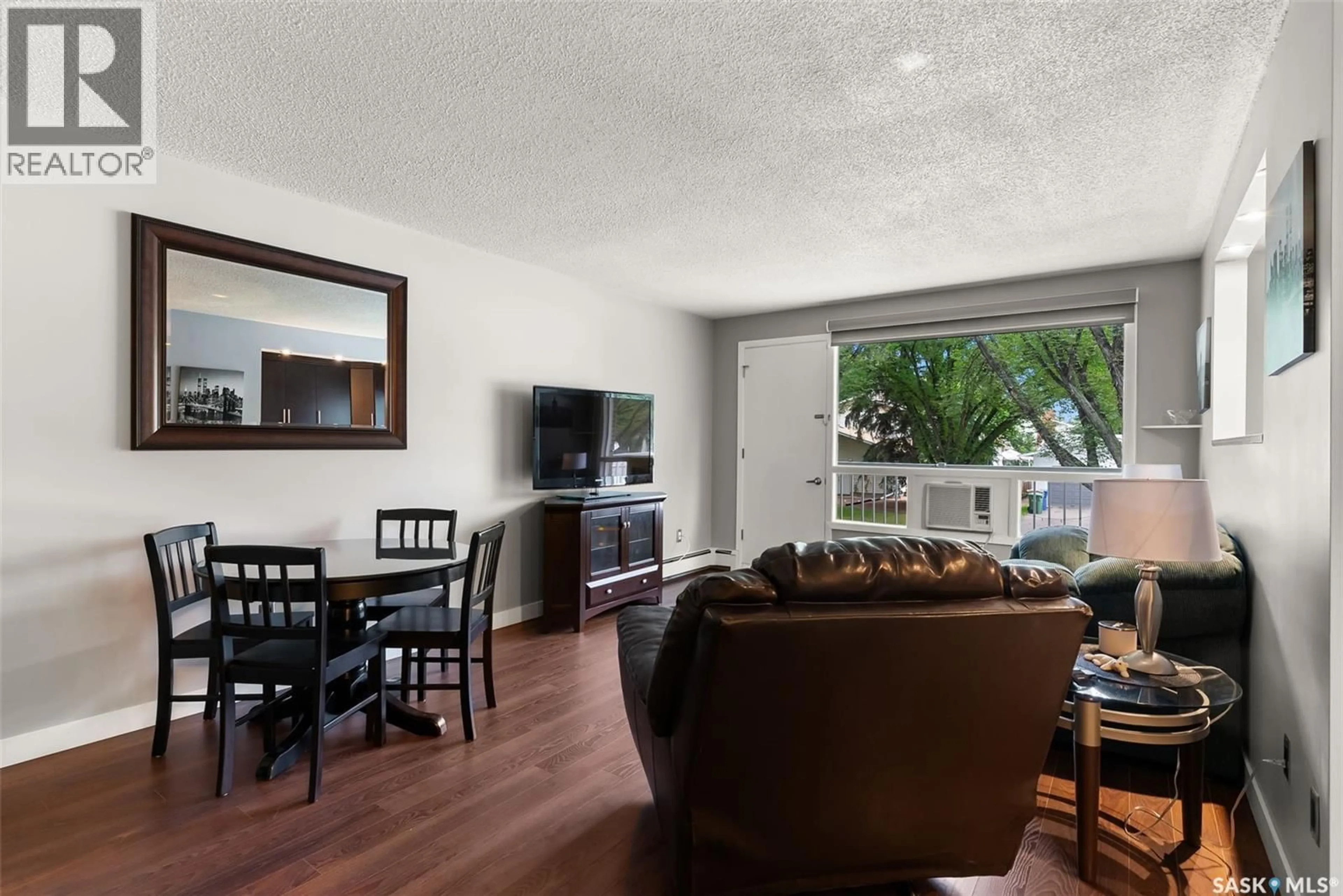 Living room with furniture, wood/laminate floor for 10 38 SPENCE STREET, Regina Saskatchewan S4S4H4