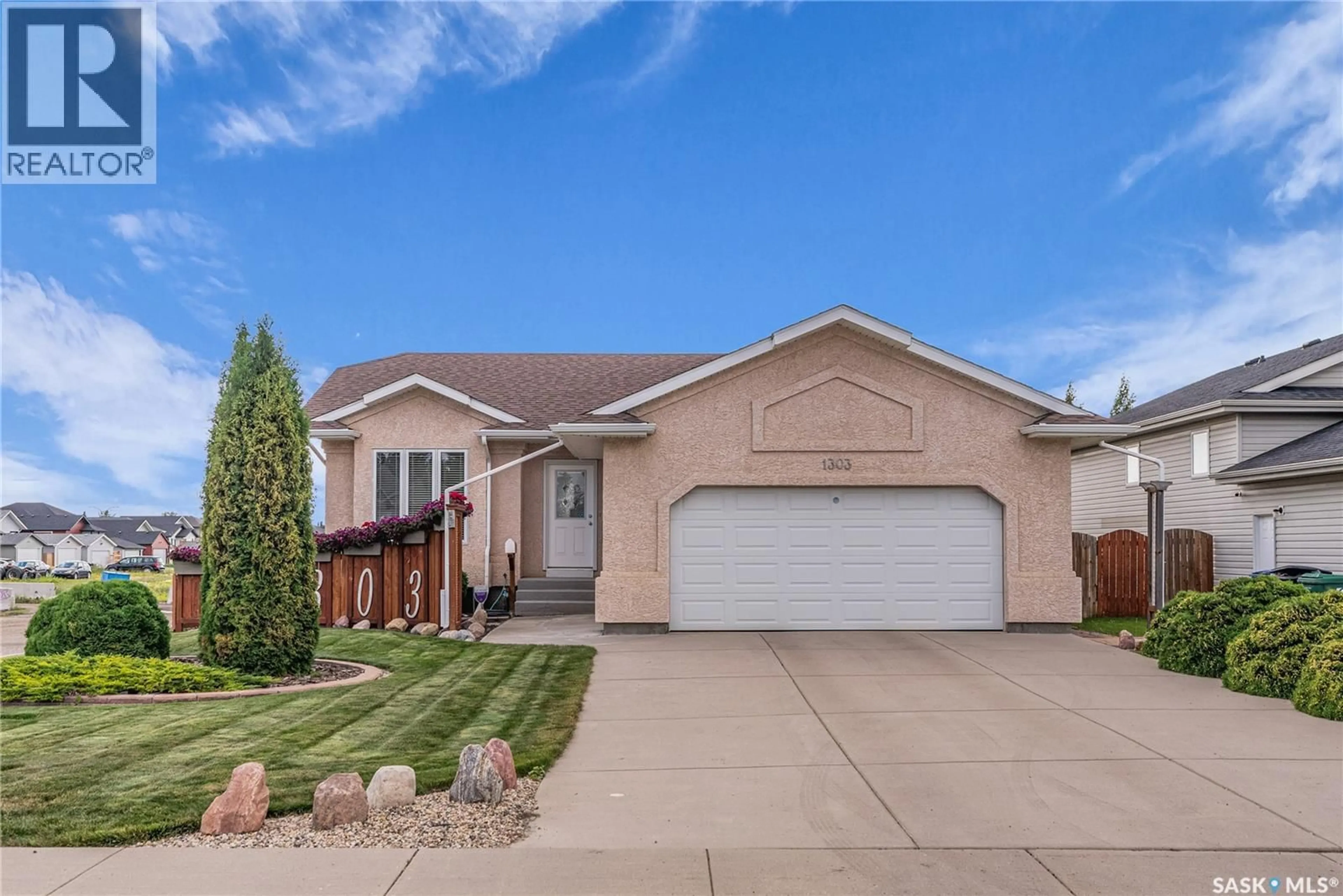 Home with vinyl exterior material, street for 1303 HUGHES DRIVE, Saskatoon Saskatchewan S7L7N1