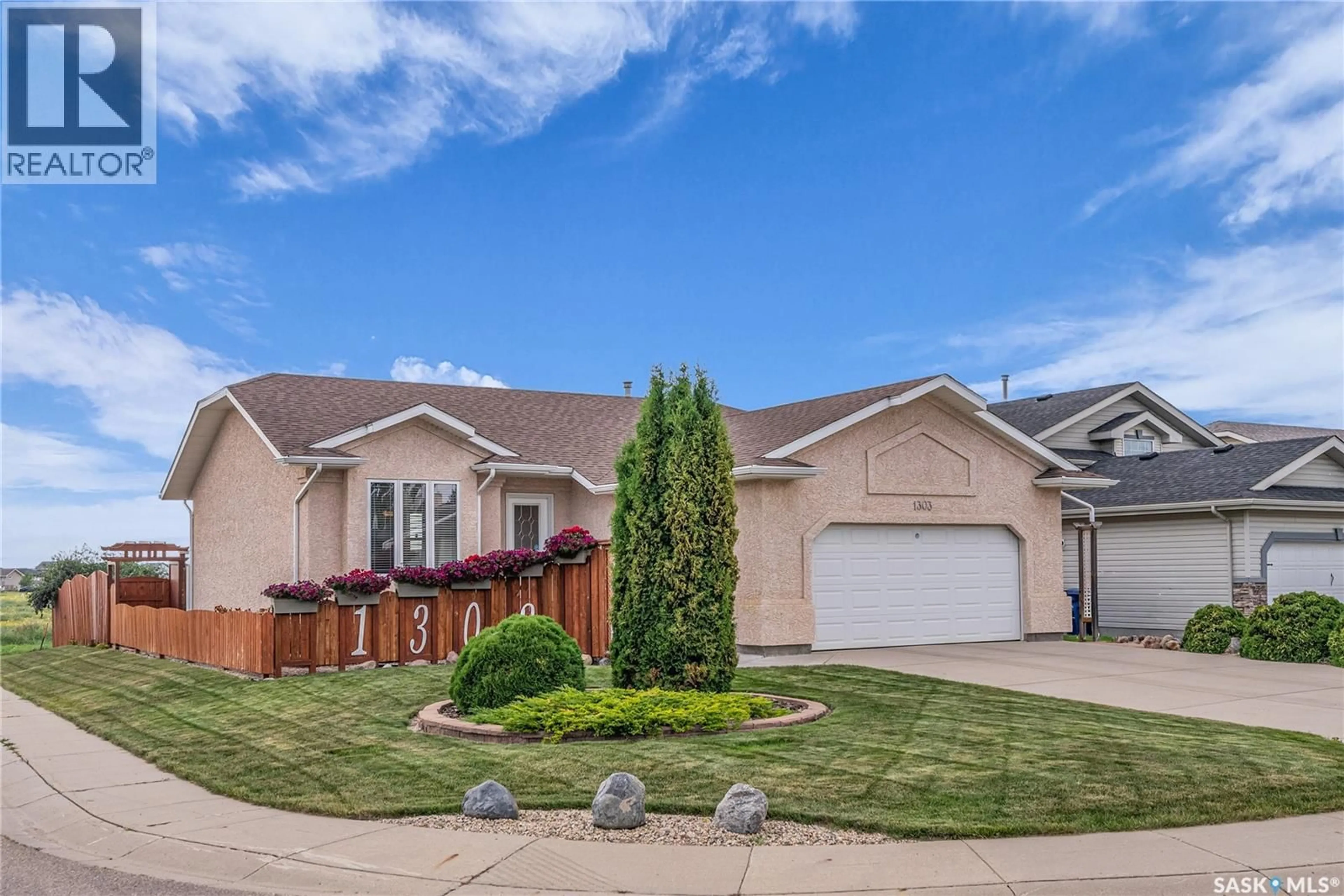 Home with vinyl exterior material, street for 1303 HUGHES DRIVE, Saskatoon Saskatchewan S7L7N1