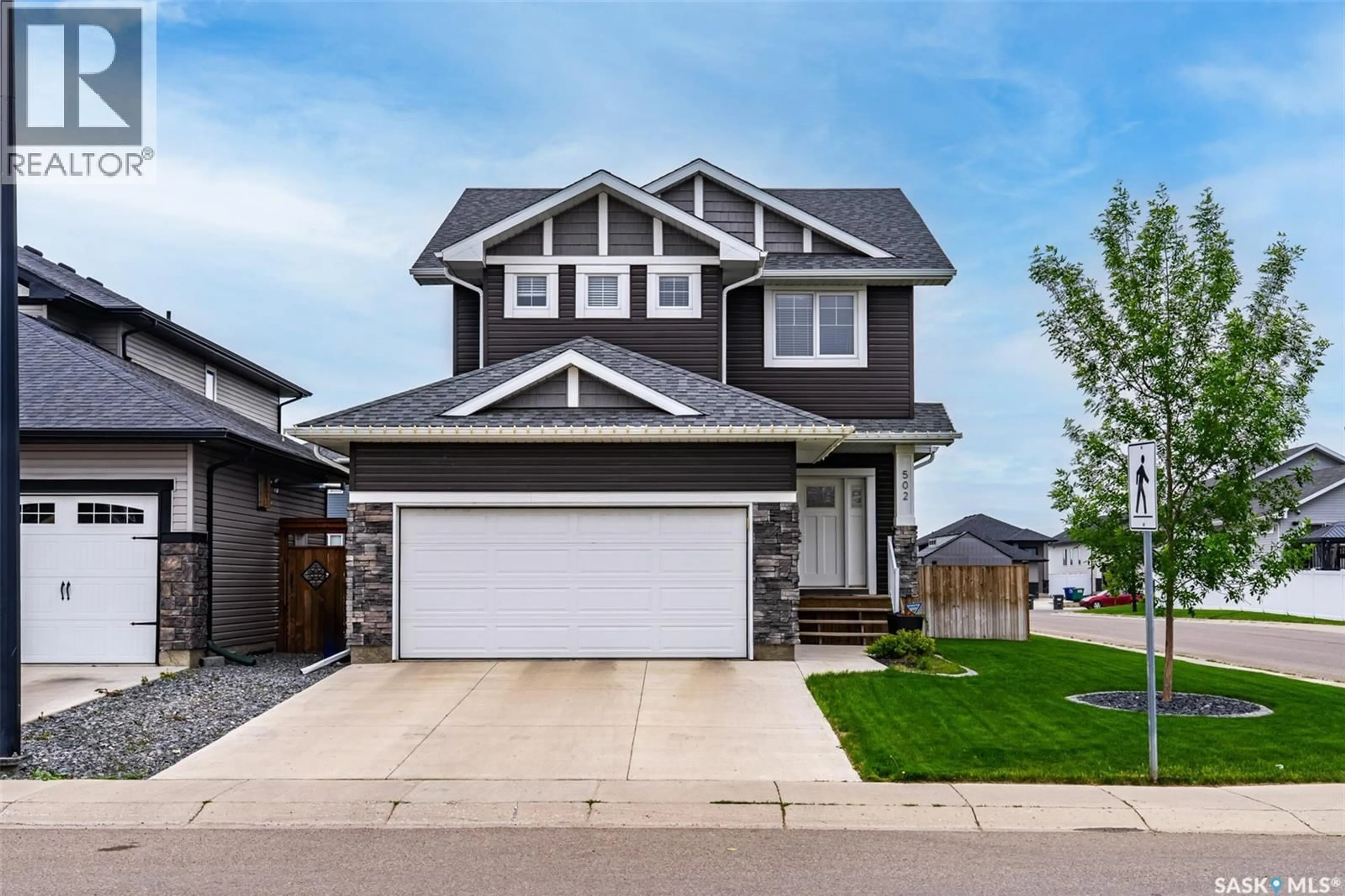 Home with vinyl exterior material, street for 502 CHILDERS CRESCENT, Saskatoon Saskatchewan S7L4P2