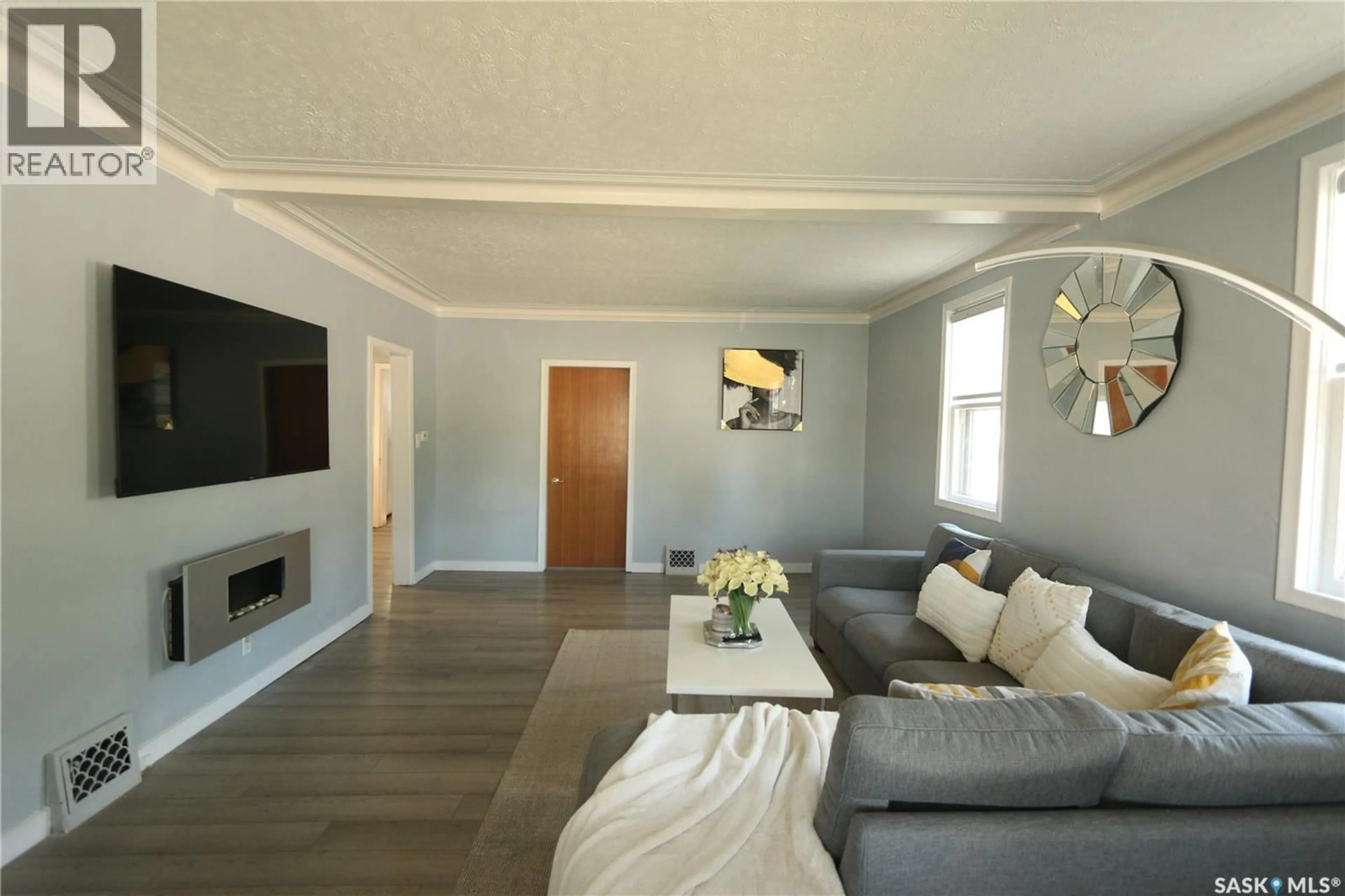 Living room with furniture, wood/laminate floor for 2100 ATKINSON STREET, Regina Saskatchewan S4N3W9
