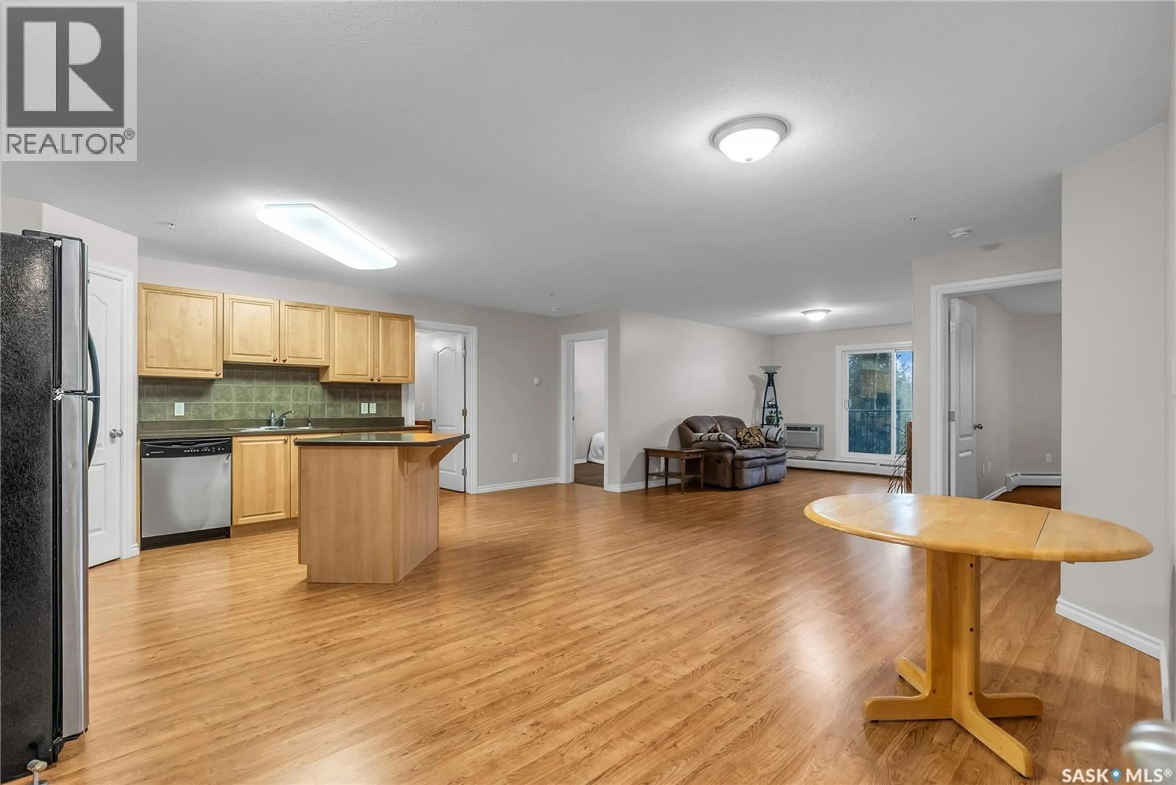 Open concept kitchen, wood/laminate floor for 100 - 211 1ST AVENUE, Warman Saskatchewan S0K4S0